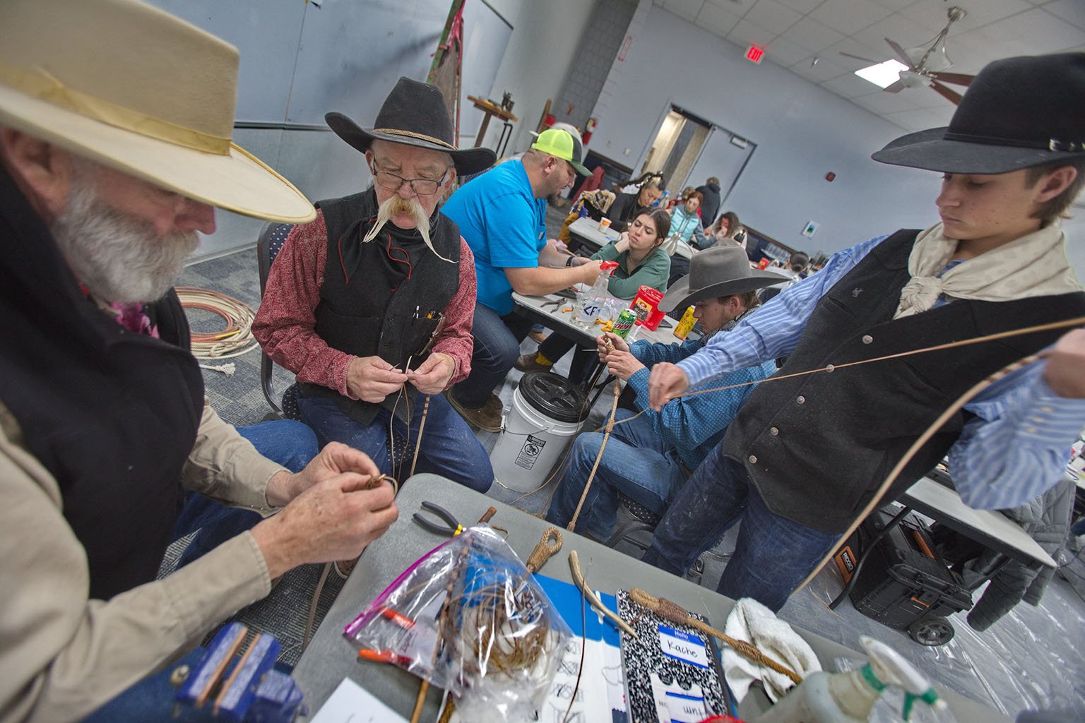 Rawhide braiders come together to share tips. Photo by Charlie Ekburg