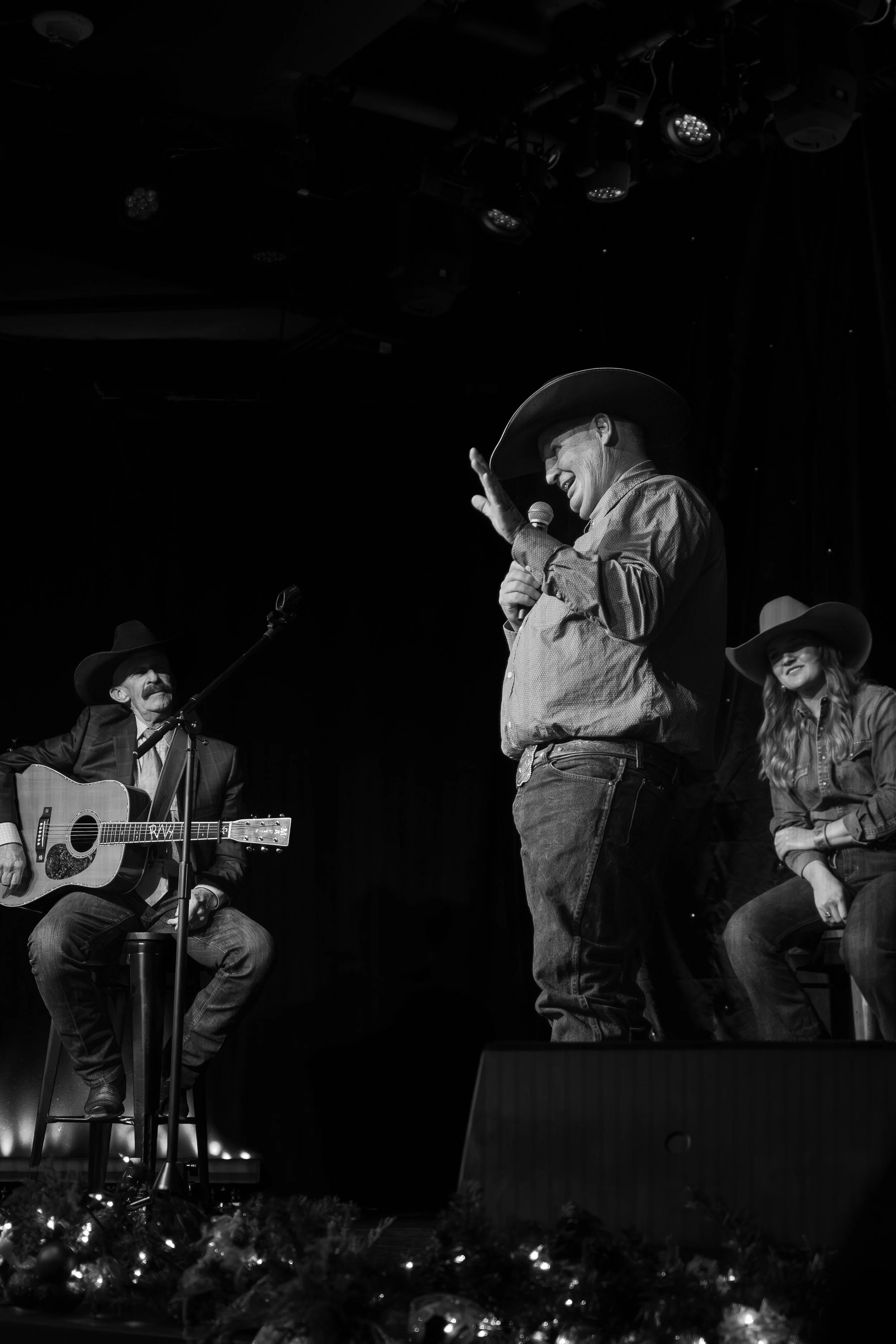 Poet Darrel Holden performs onstage next to R.W. Hampton