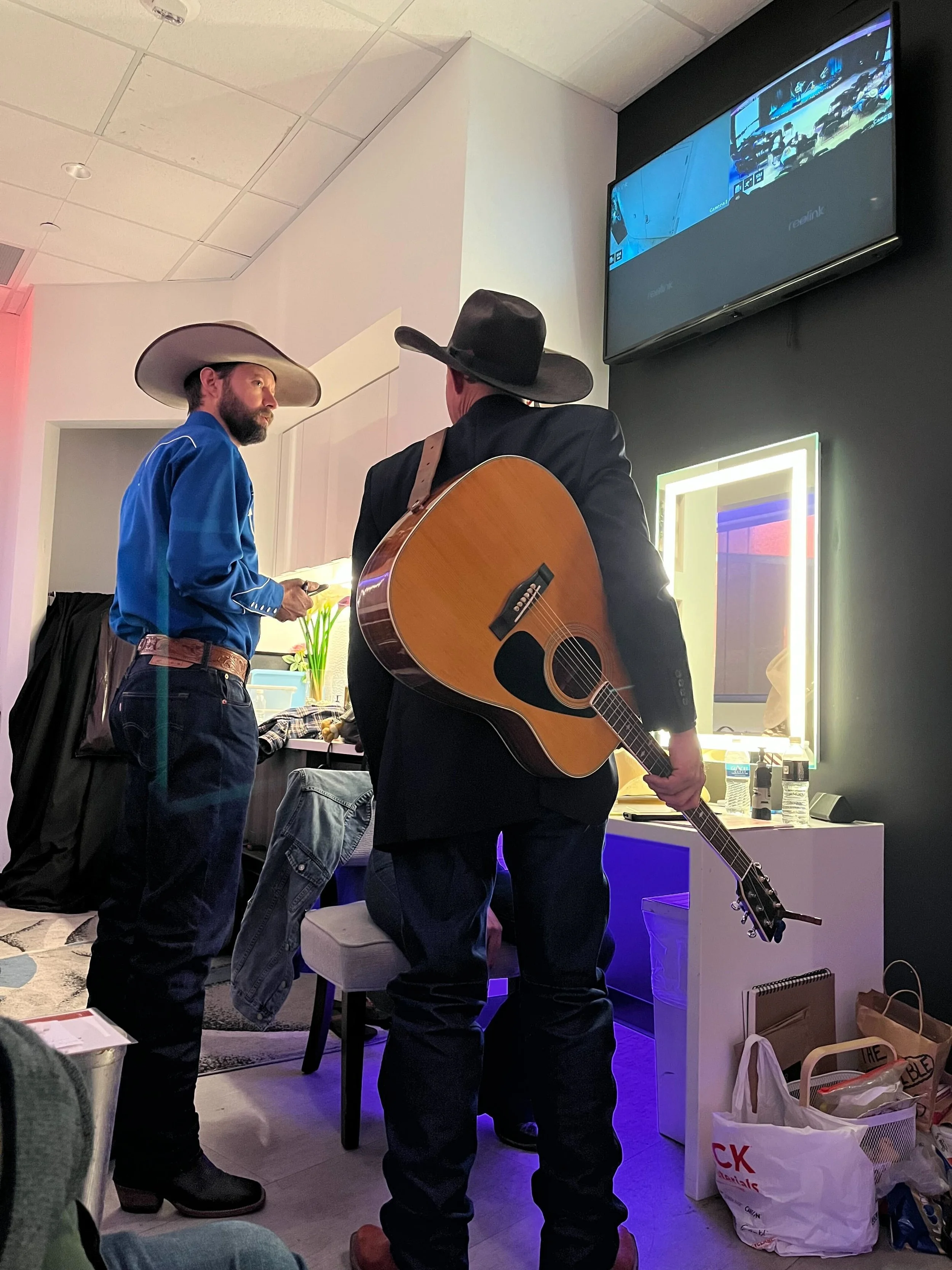 Jake Riley and musician Matt Robertson prepare for their show in the green room