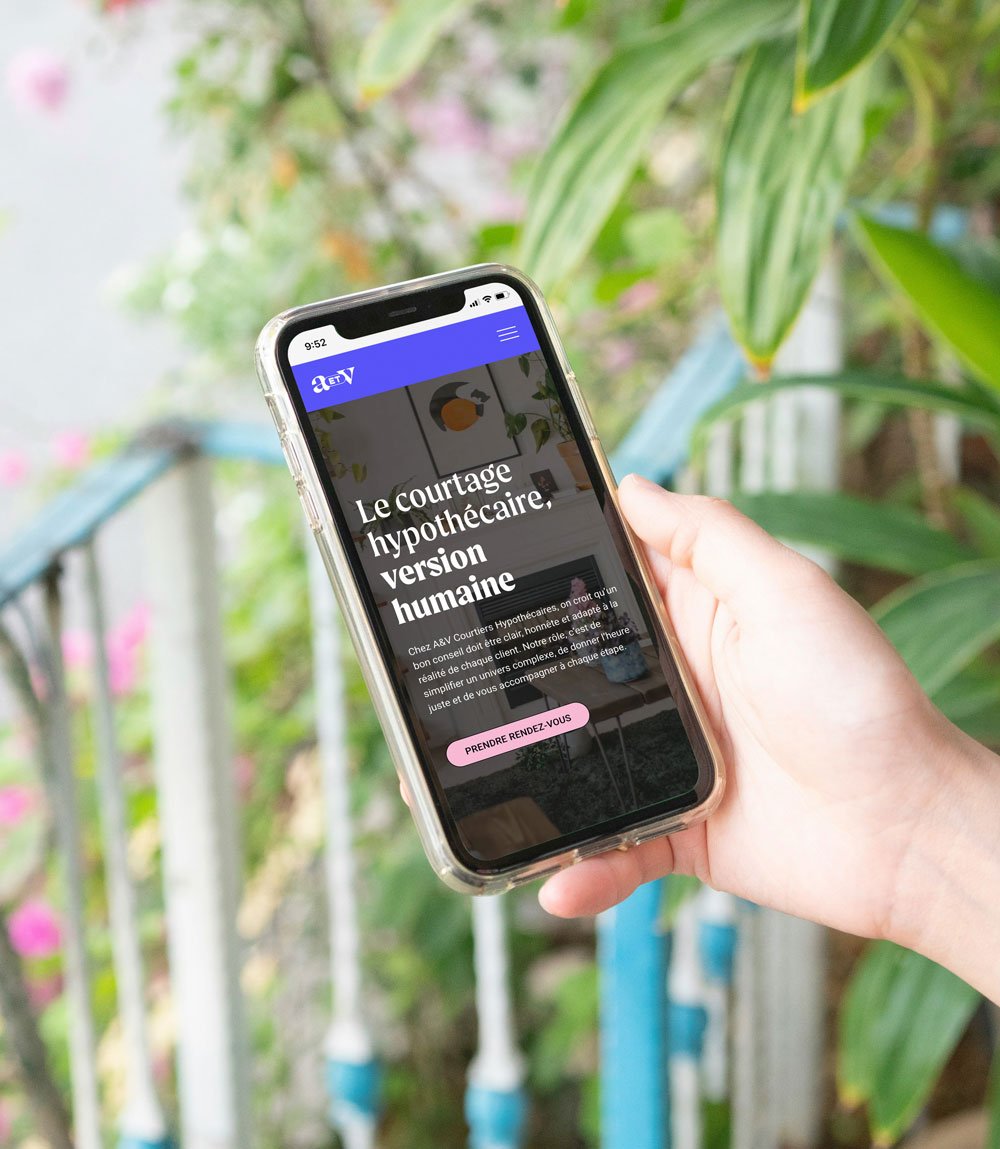 Someone holding phone looking at AetV website