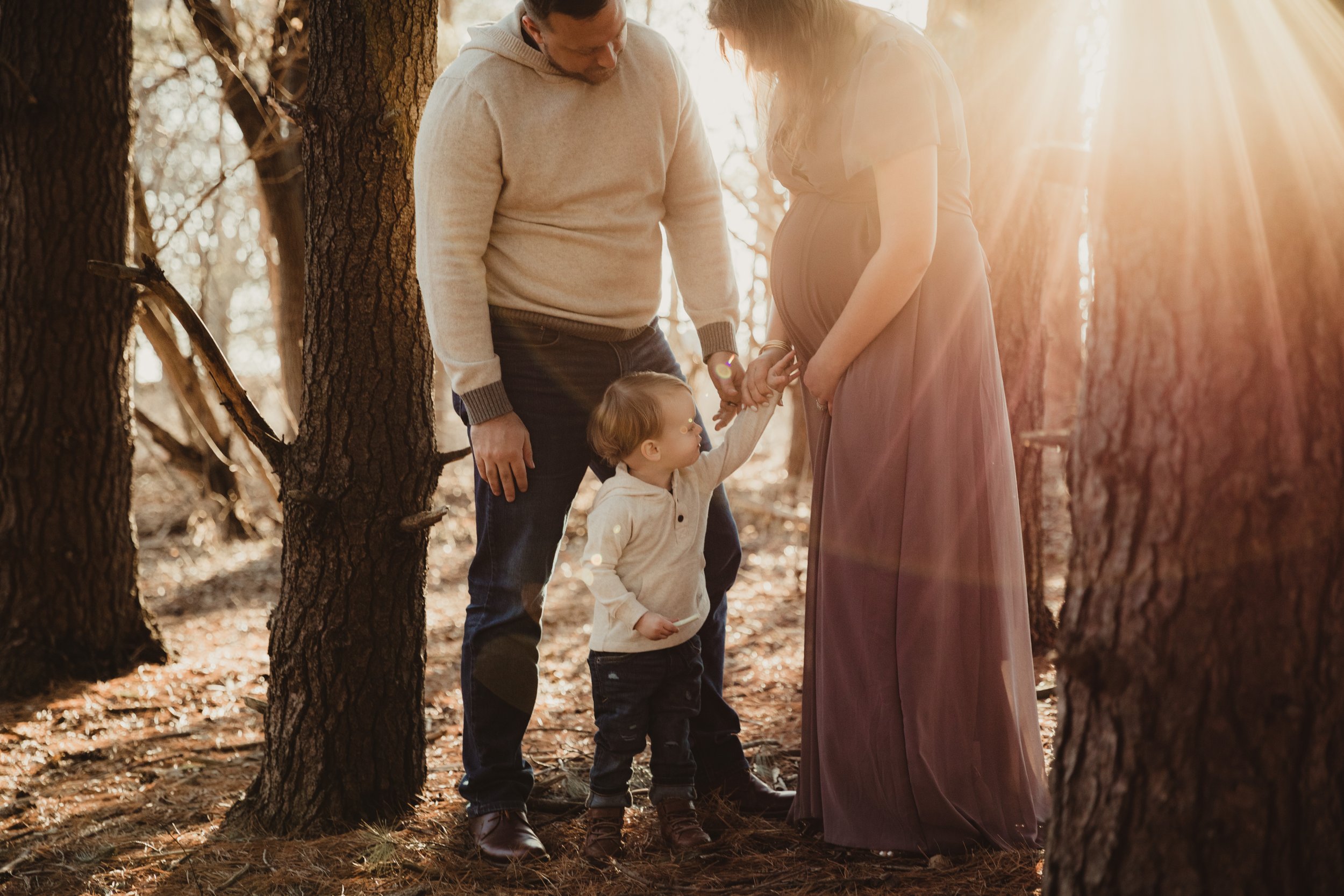 son_points_at_moms_pregnant_belly_sunset.jpg.jpg