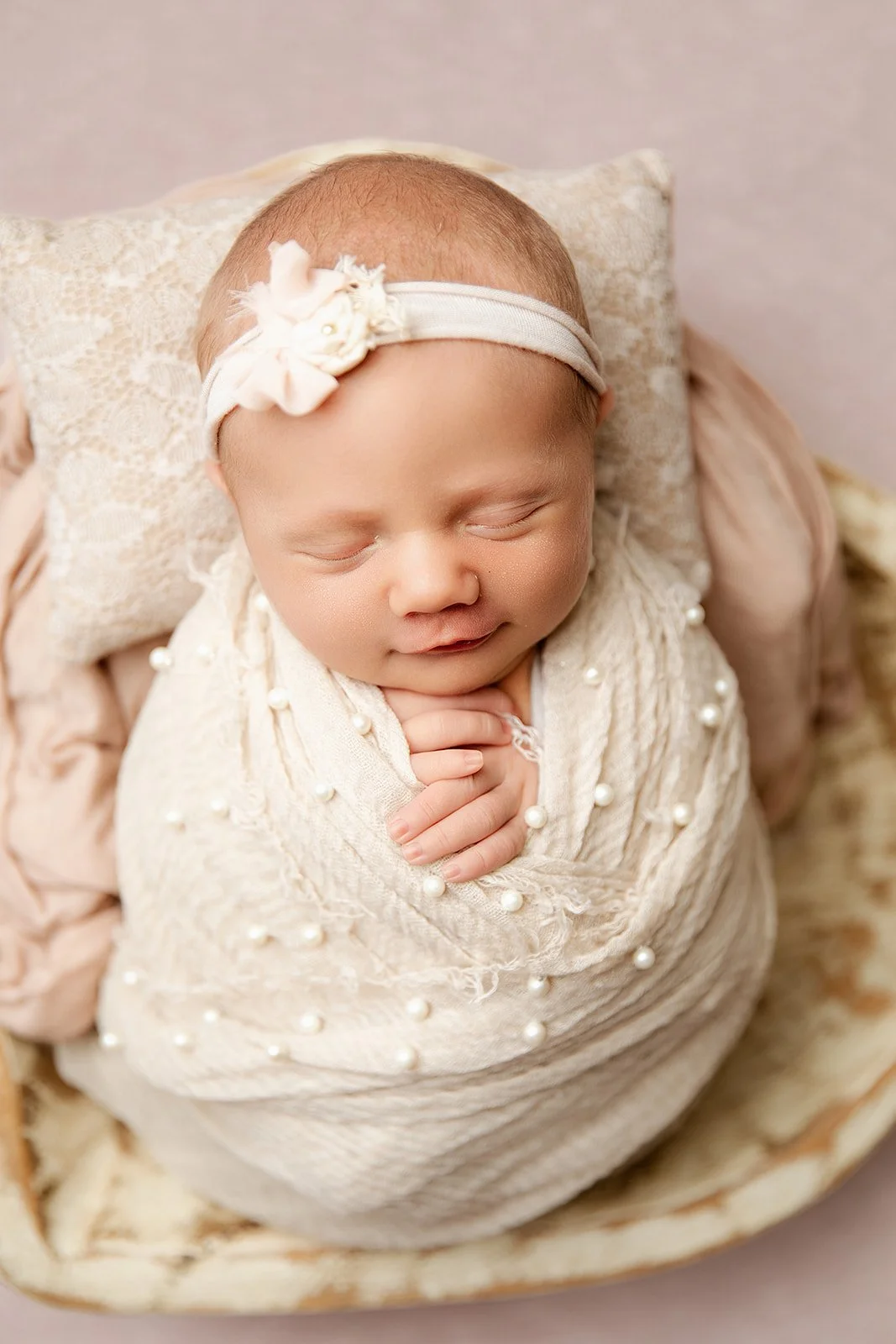 baby_girl_smirks_wrapped_in_pearls