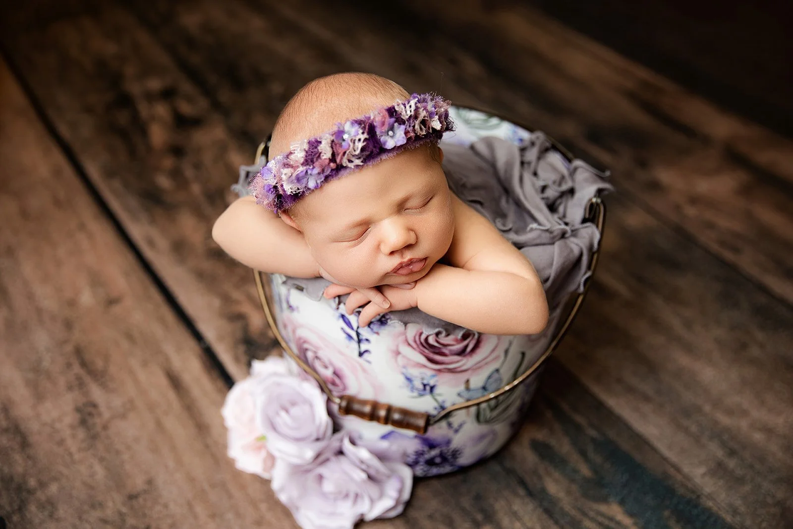 baby_girl_in_purple_floral_halo_sleeps_in_bucket