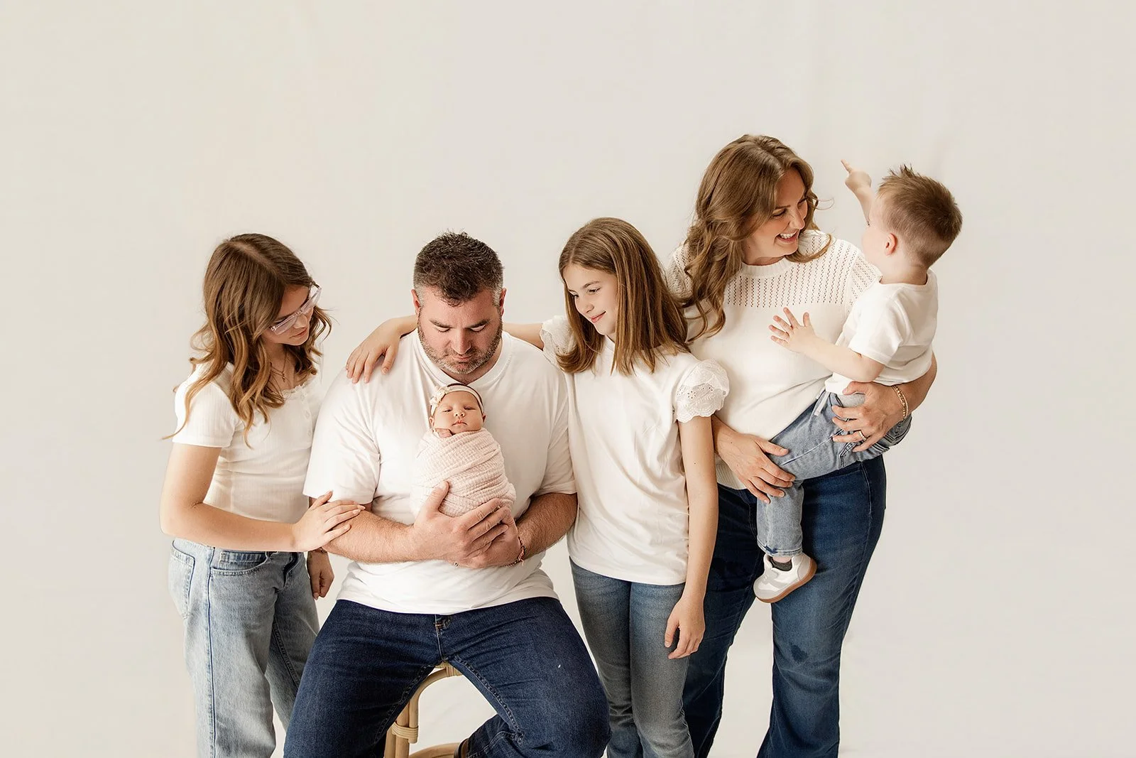 family_enjoys_newborn_baby_girl