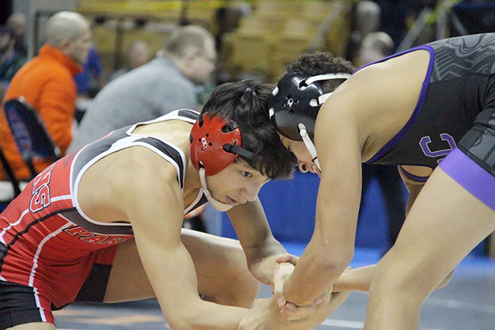 ROSS MARTIN/Citizen photos Park Hill sophomore Kelvin Eblen, left, ties up with CBC’s Cevion Severado during a Class 4 106-pound semifinal in the Missouri State Wrestling Championships on Friday, Feb. 19 at Mizzou Arena in Columbia, Mo. 