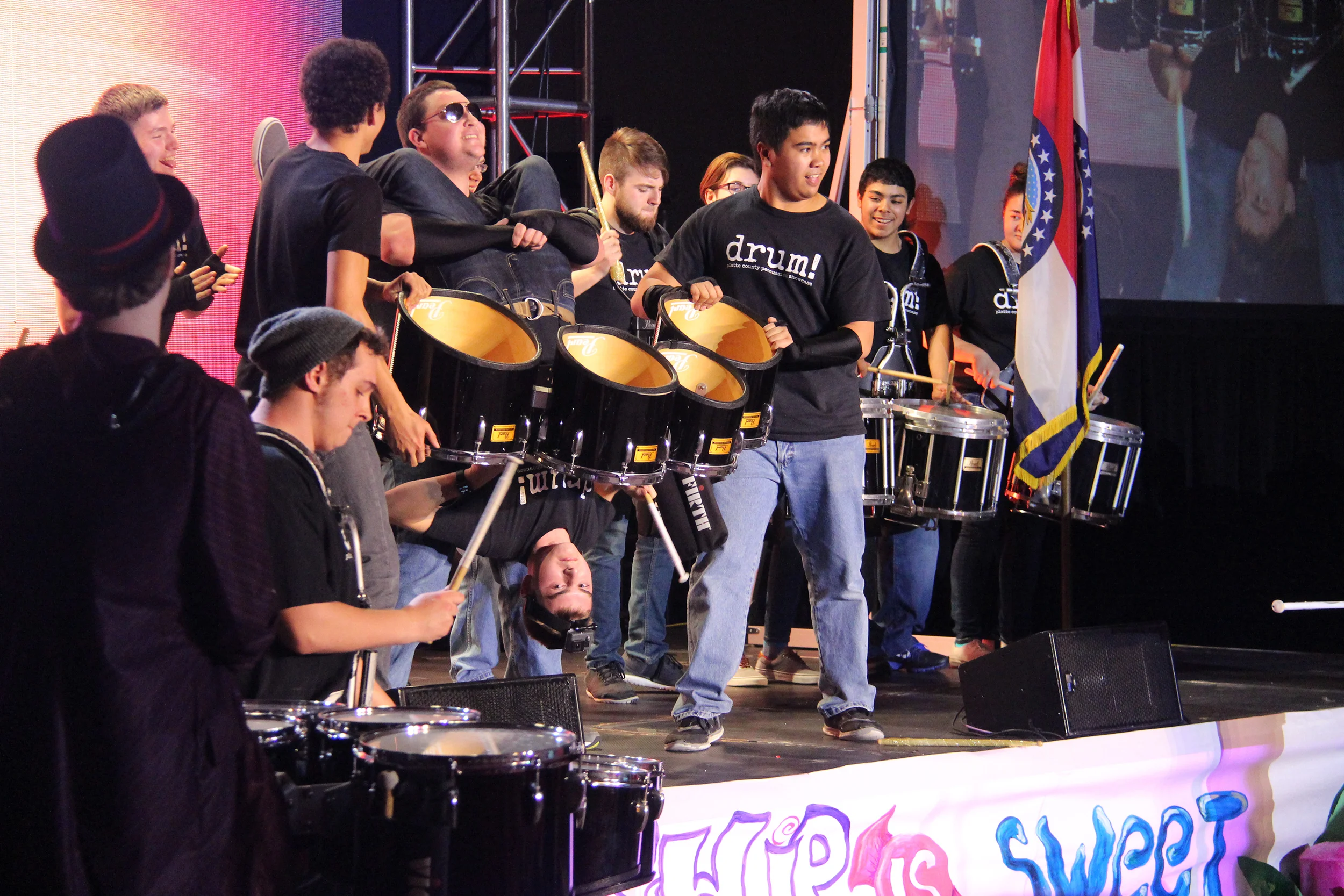ROSS MARTIN/Citizen photo Members of Platte County’s drum line, including from left to right Brady Burress, John Morrione, Michael Sears, Adrian Langley, Nathan Itao, Cade McGinness, Dalton Grenier, Christian Estella, Zoe Bedrosian, Pedro Garcia and Peyton Itao performed during the opening ceremony of the Missouri Association of Student Councils annual convention held last week at Platte County High School. Nathan Itao was holding McGinness, a sophomore, upside down for a short portion of the performance, drawing wild applause from the more than 1,000 students and advisors in attendance.