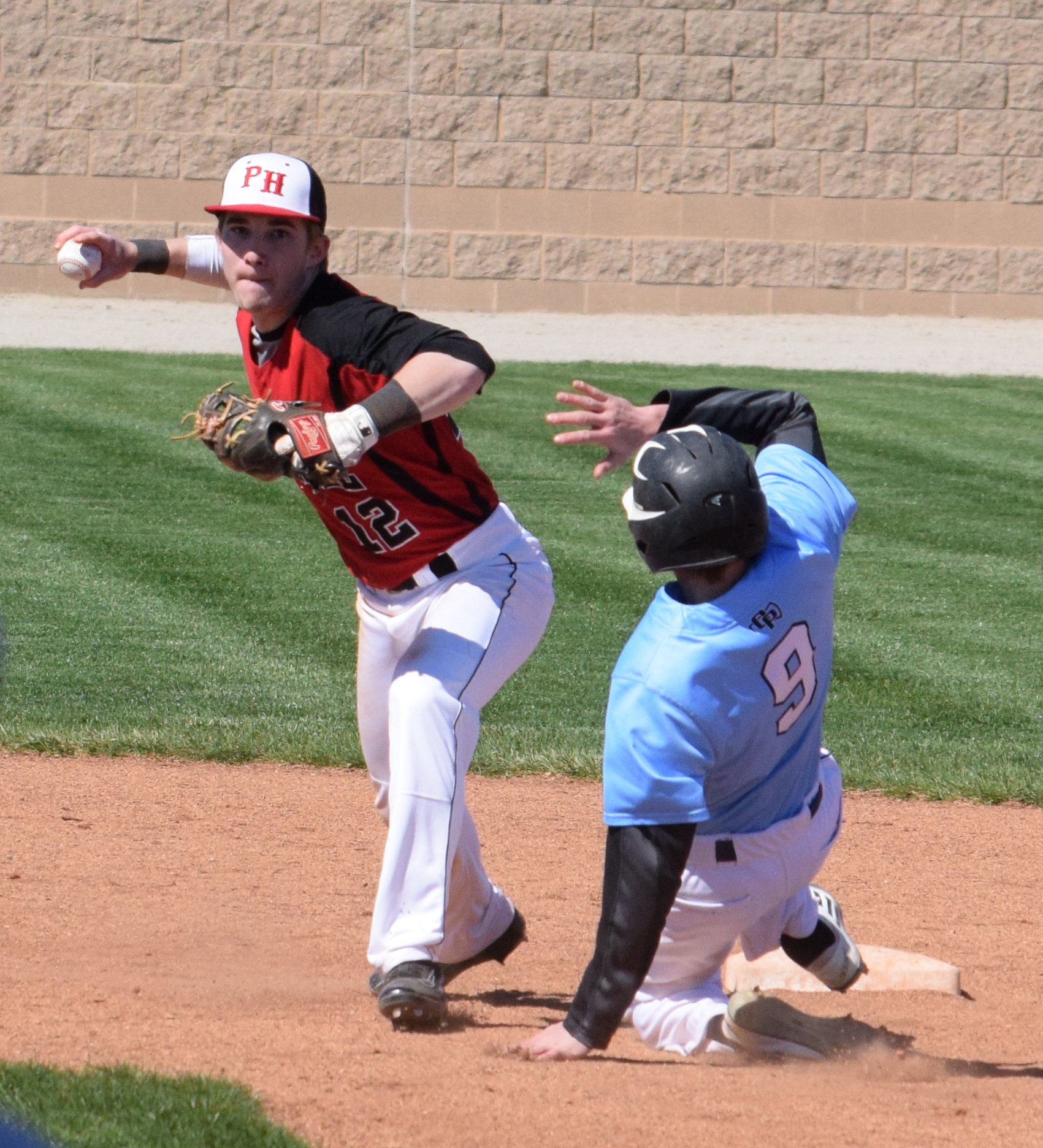 BRYCE MERENESS/Citizen photo Park Hill senior shortstop Chase McCollom attempts to turn a double play against Oak Park on Saturday, April 2 at Park Hill High School in Kansas City, Mo. Park Hill went on to split the scheduled doubleheader with a 9-8 win and a 3-0 loss. 