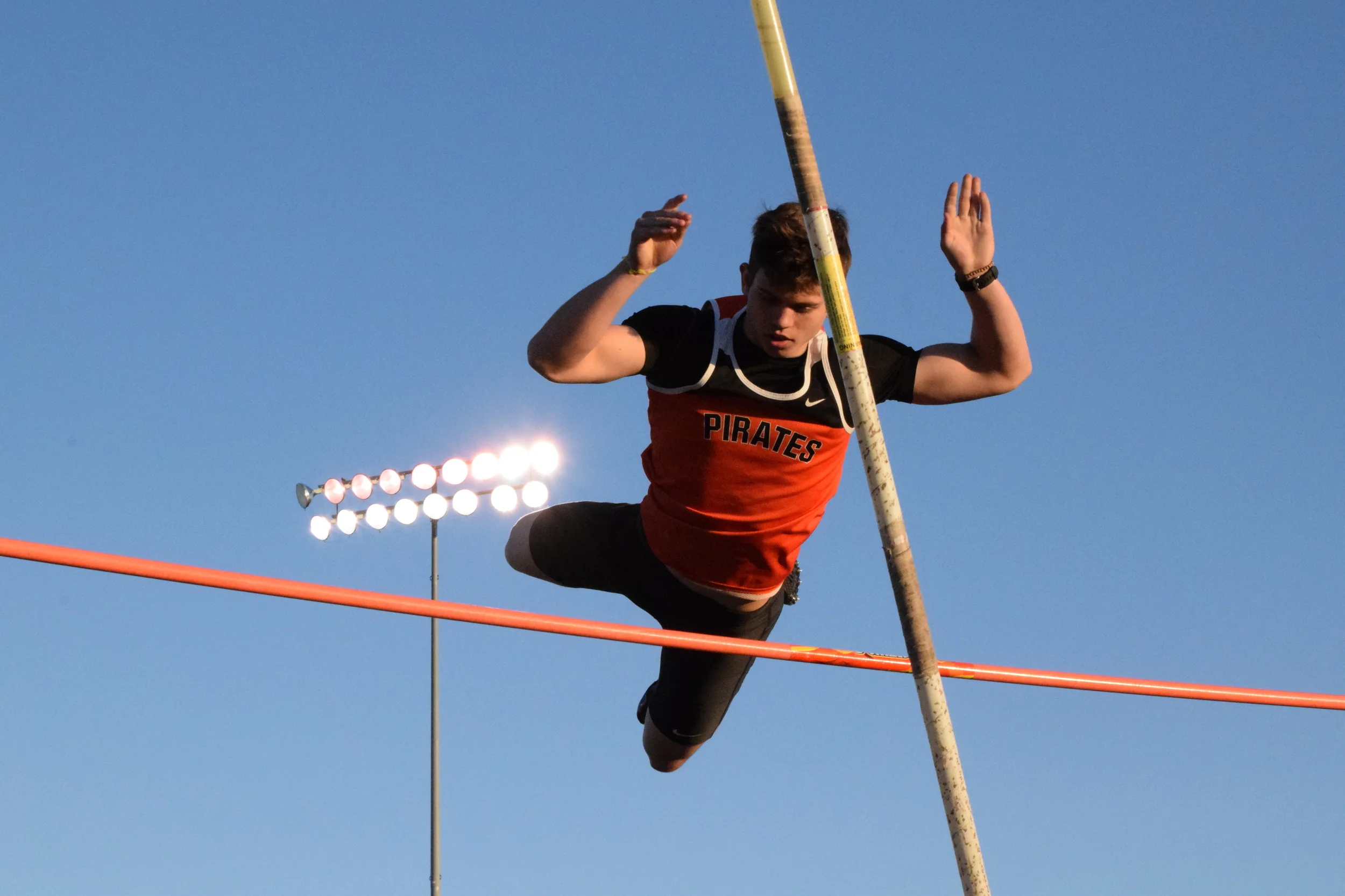 BRYCE MERENESS/Citizen photo Platte County’s Jake Tomlinson clears the bar during the pole vault competition of the Kearney Classic on Friday, April 8 at Kearney High School in Kearney, Mo.