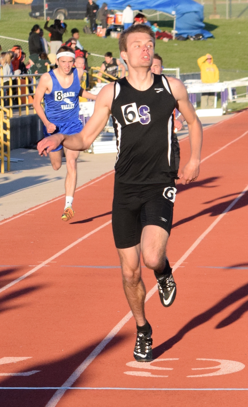 BRYCE MERENESS/Citizen photo Park Hill South junior Ryan Rippy crosses the line first as he glances over his shoulder in the 400-meter dash in the Kearney Classic on Friday, April 8 at Kearney High School in Kearney, Mo. A junior transfer, Rippy won the 400 and also ran on the Panthers’ 4x200 and 4x400 relays.