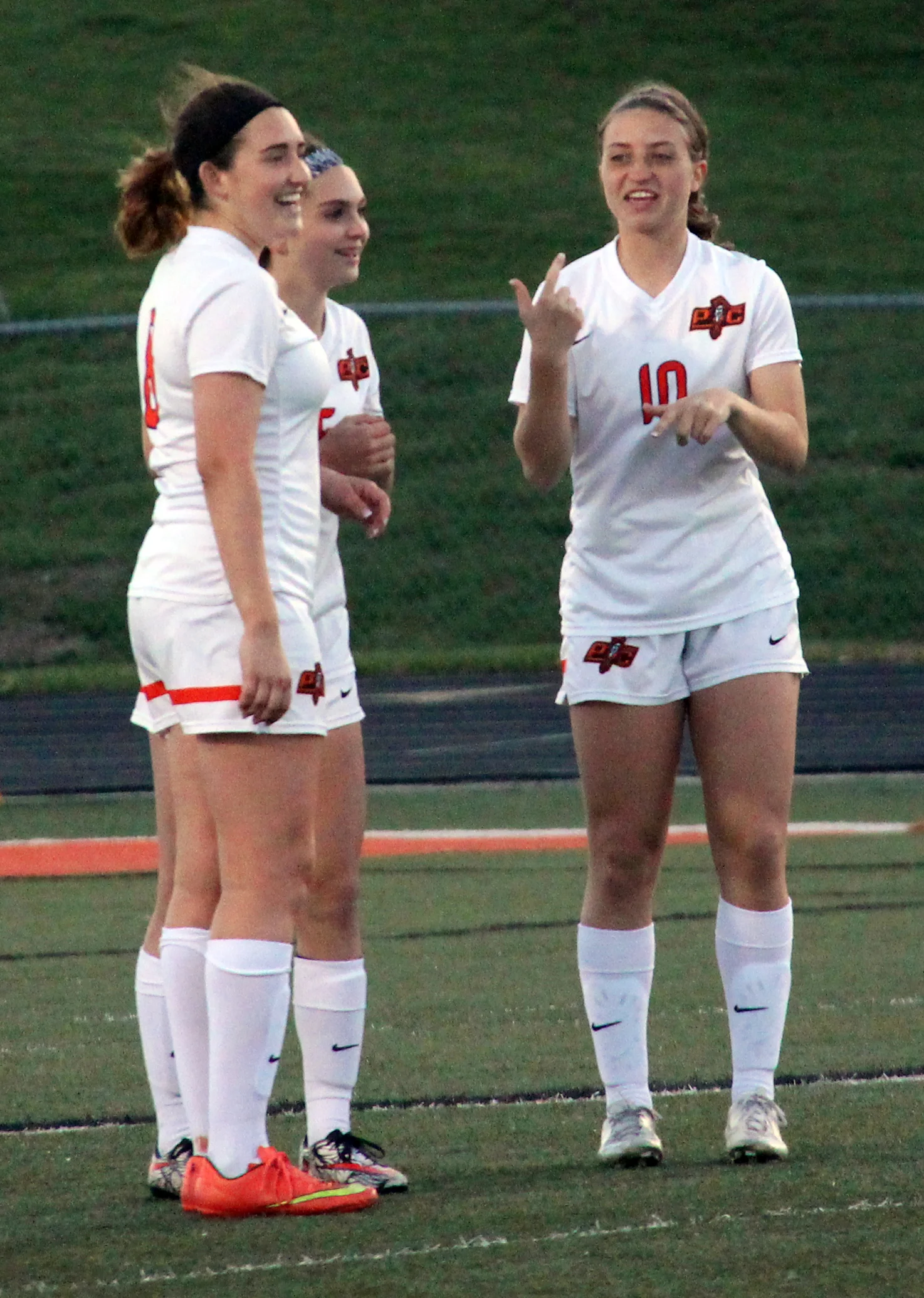 ROSS MARTIN/Citizen photo Platte County senior Haley Valentine, left, freshman Madeline Donnelli, center, and Boe share a laugh prior to the second half kickoff. The three start on the backline for Platte County.