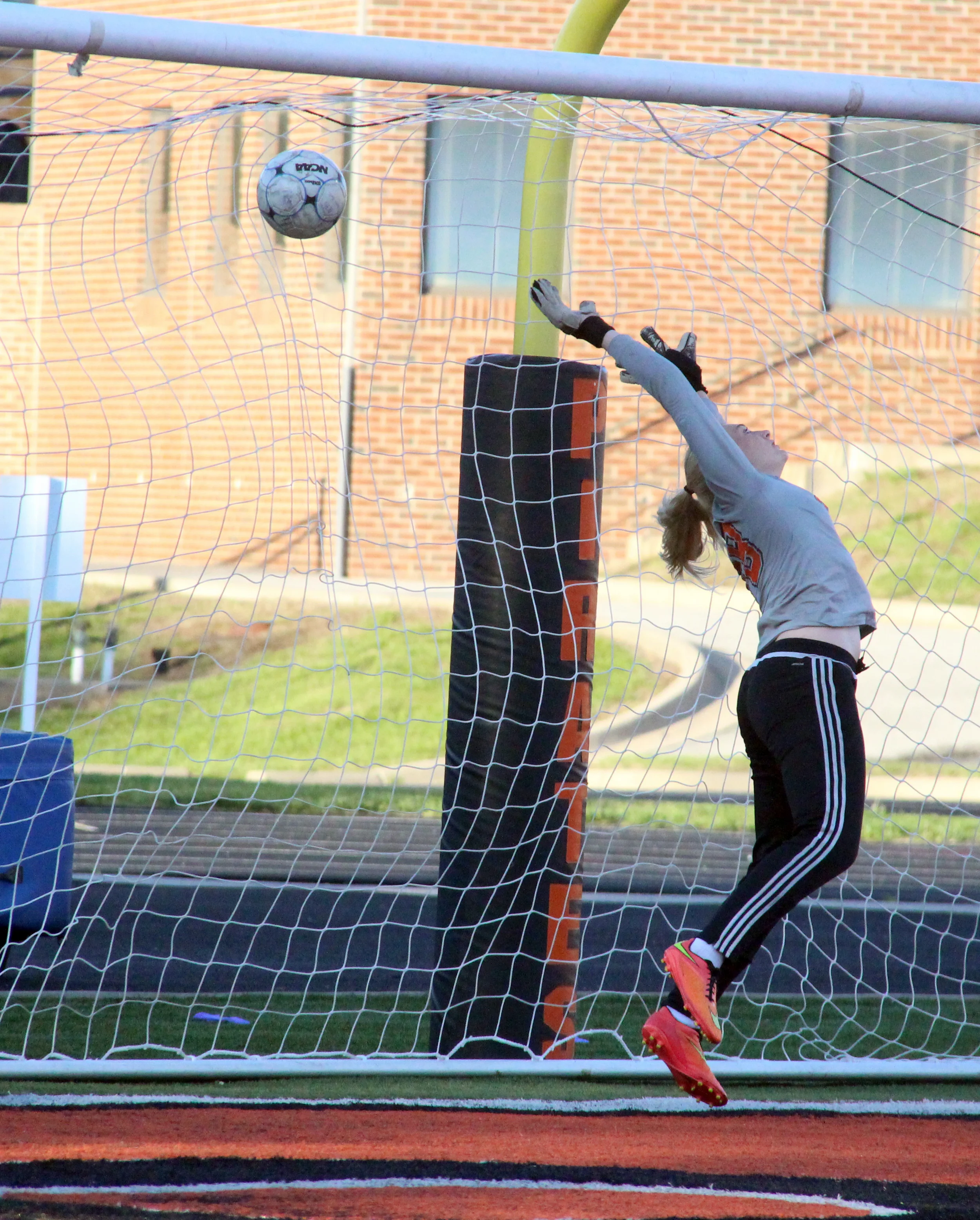 ROSS MARTIN/Citizen photo Platte County goalkeeper Faith Burtchell tips the ball while trying to save a penalty kick against Kearney on Wednesday, April 27 at Pirate Stadium.