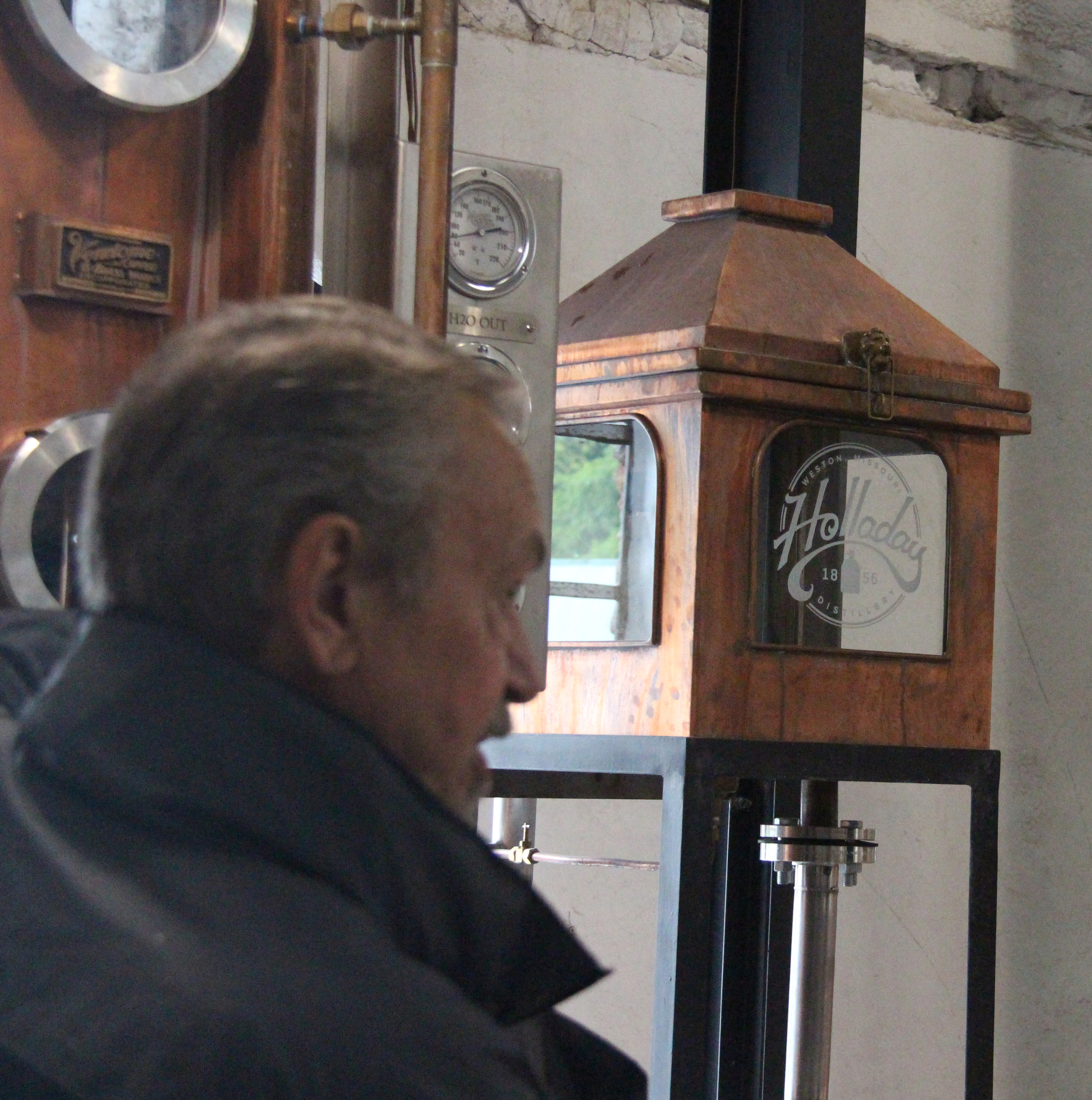 ROSS MARTIN/Citizen photo Tour guide Jim Stevens talks in front of a still Holladay Distillery during a tour at the facility Friday, May 13 in Weston, Mo. McCormick Distillery recently restarted distilling alcohol on site and giving tours after a 25-year hiatus.