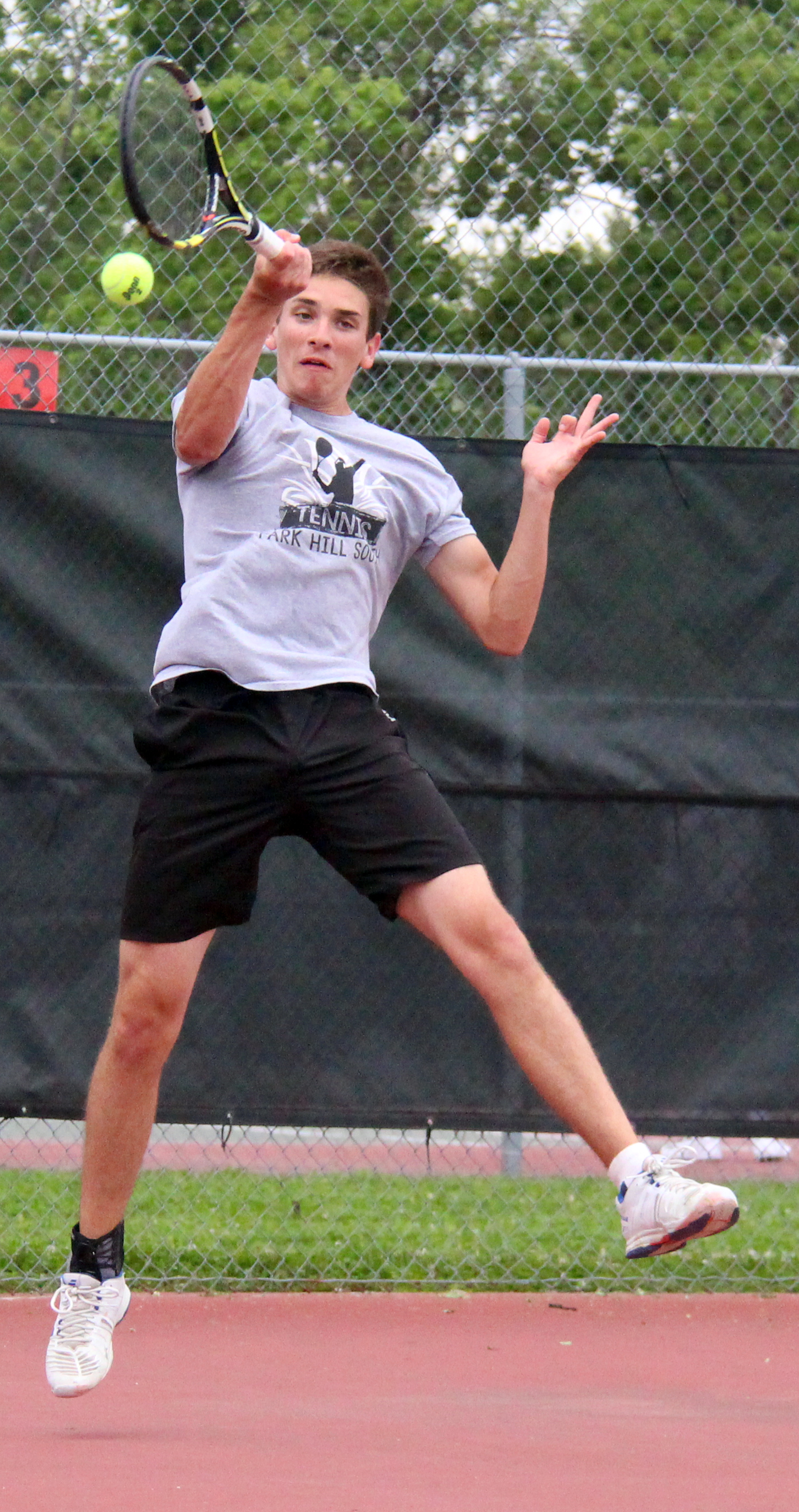 ROSS MARTIN/Citizen photo Park Hill South senior JD Nassab hits a return during a doubles match in the Class 2 District 15 championship dual with Park Hill on Wednesday, May 11 at Barry Park in Kansas City, Mo. 