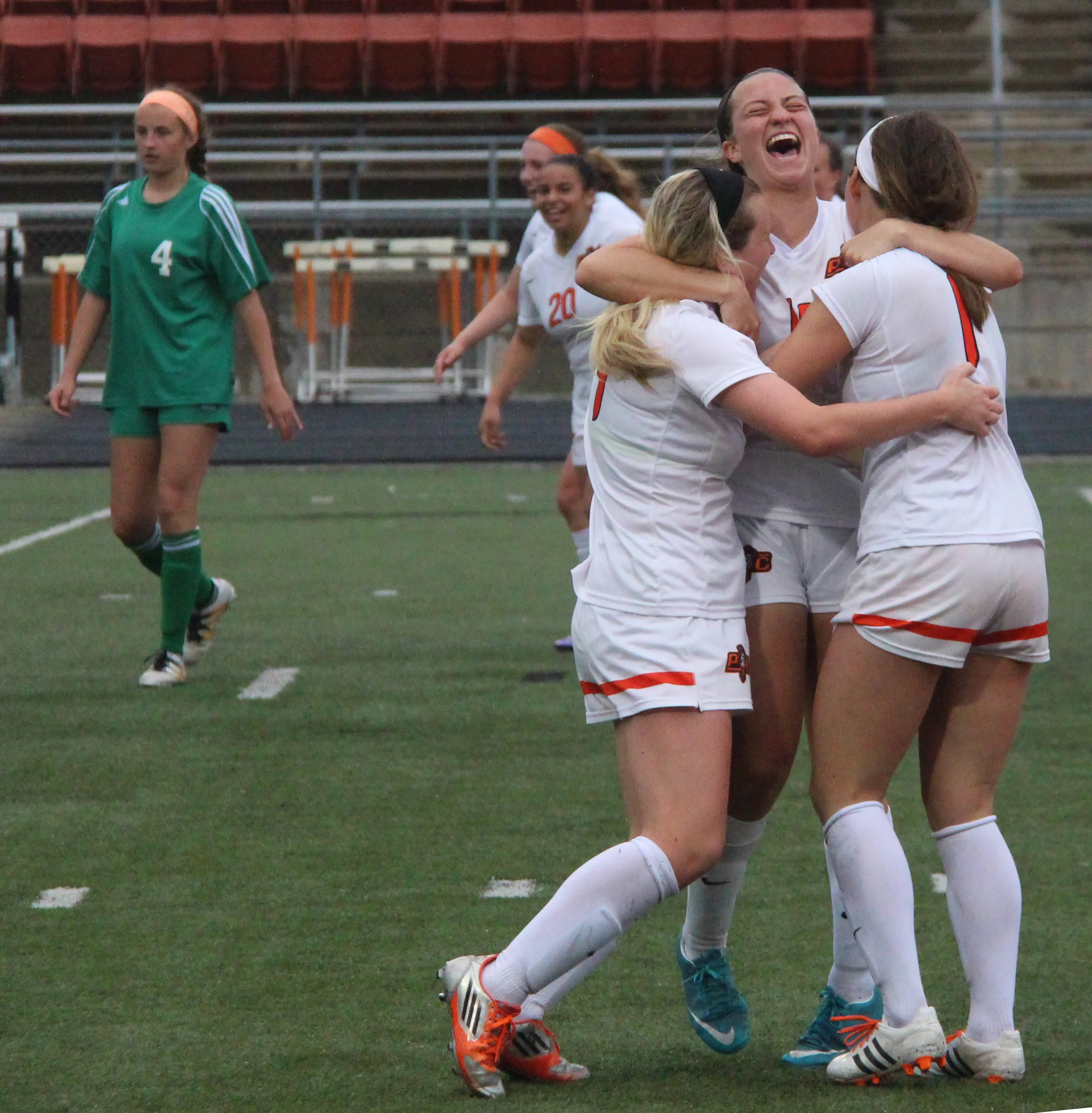 ROSS MARTIN/Citizen photo Platte County junior defender Calle Boe, center, hugs junior midfielder Kianna Castro, left, and senior midfielder Brooke Zenner after Zenner's corner kick set up Destinee Smith (not pictured) for the winning goal in overtime against Smithville in the Class 3 District 16 championship game Thursday, May 19 at Pirate Stadium.