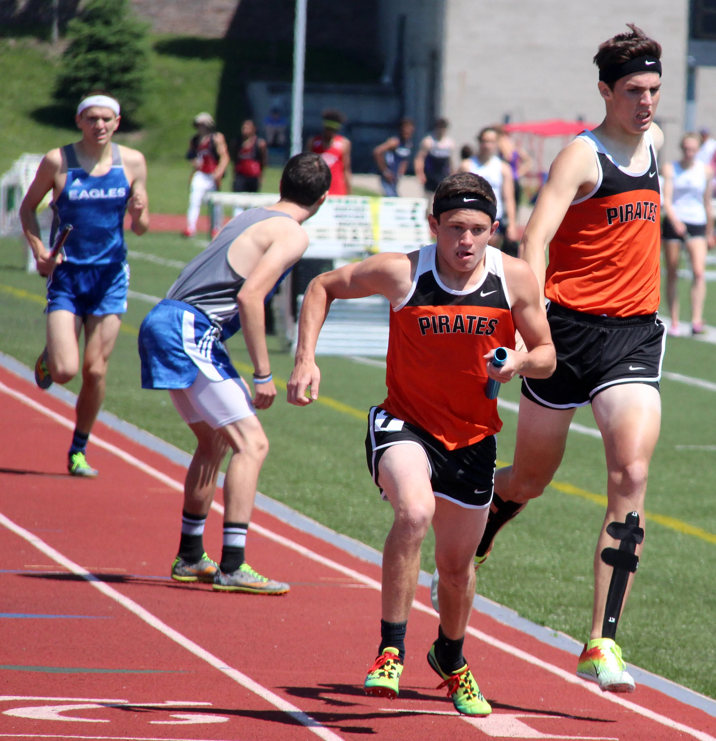 ROSS MARTIN/Citizen photos Platte County’s JD Crawford, center, takes a handoff from Keegan Cordova in the Class 4 Sectional 4x800-meter relay Saturday, May 21 at North Kansas City District Activities Complex in Kansas City, Mo.