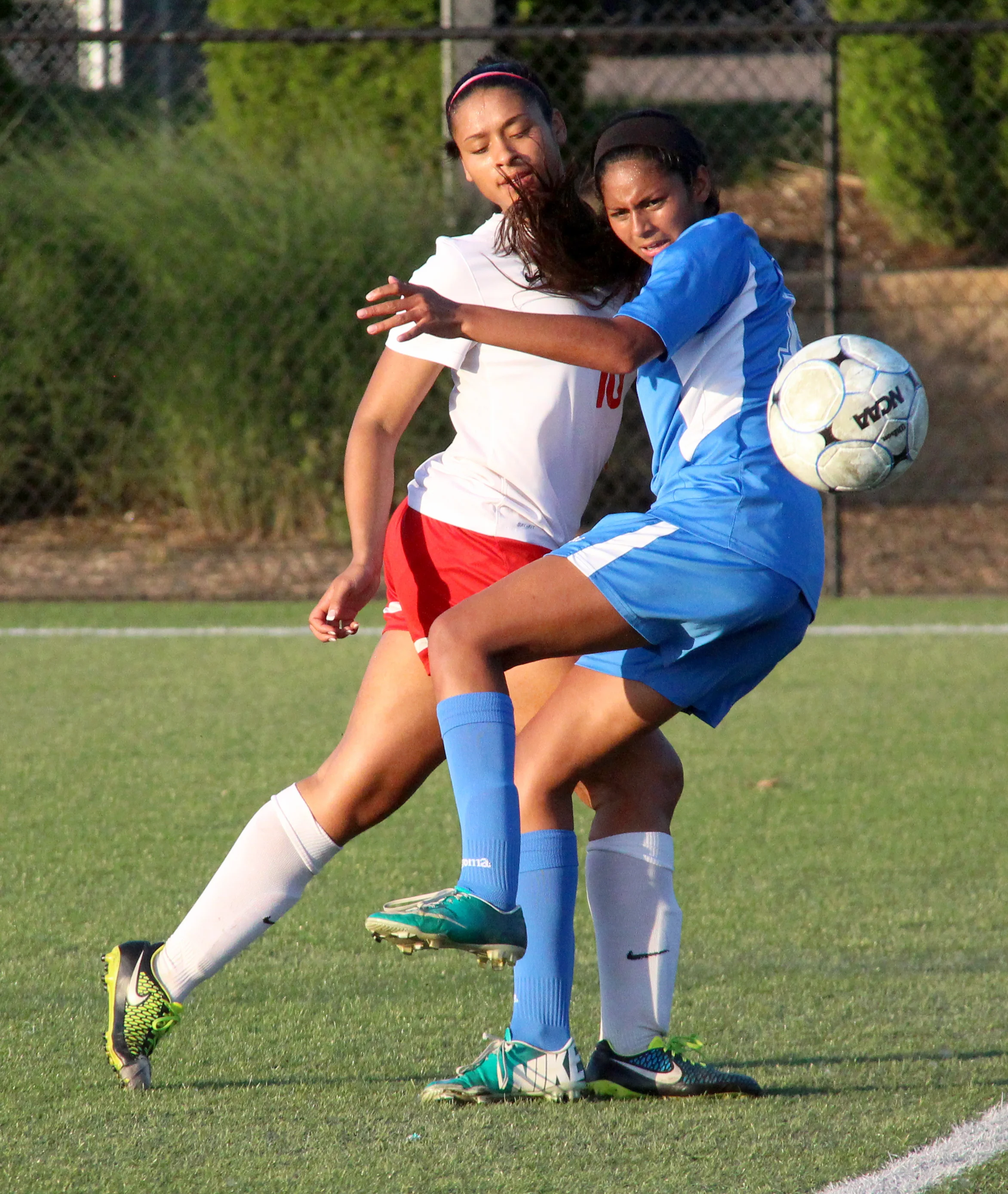 ROSS MARTIN/Citizen photo Park Hill senior midfielder Raena Woodruff, left, collides with a Liberty defender during the second half of a Class 4 sectional matchup Tuesday, May 24 at Park Hill District Soccer Complex in Riverside, Mo.