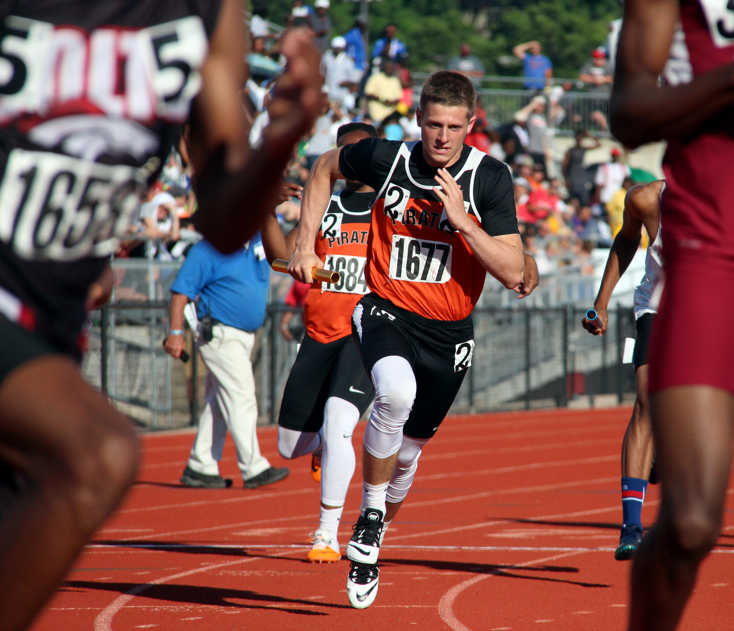 ROSS MARTIN/Citizen photo Platte County senior Tyler Clemens, center, takes a handoff in the 4x400-meter relay Saturday, May 28 during the Class 4 Missouri State Track and Field Championships at Adkins Stadium in Jefferson City, Mo. 