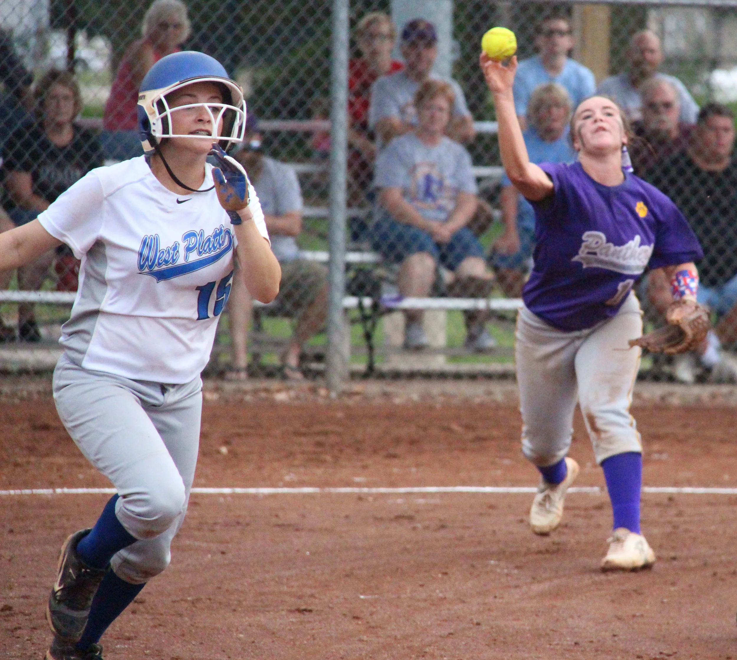 ROSS MARTIN/Citizen photo North Platte junior shortstop Alley Rickel, right, makes a throw to first base as West Platte’s Alex LaRoe hustles down the line during a game Thursday, Sept. 8 at Dean Park in Dearborn, Mo. 
