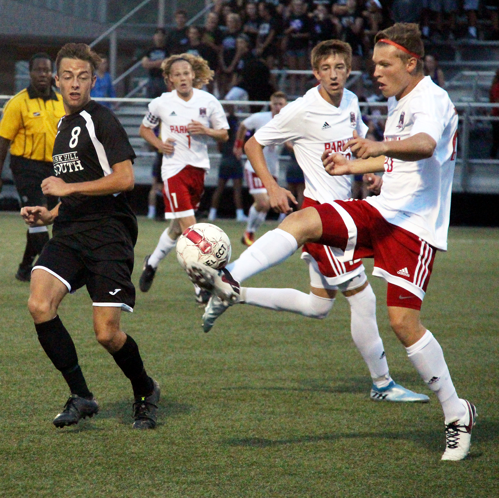 ROSS MARTIN/Citizen photo Park Hill senior defender Jackson Foutch, right, hits a clearance in front of Park Hill South forward Tyler Pisoni on Thursday, Sept. 8 at Park Hill District Soccer Complex in Riverside, Mo.