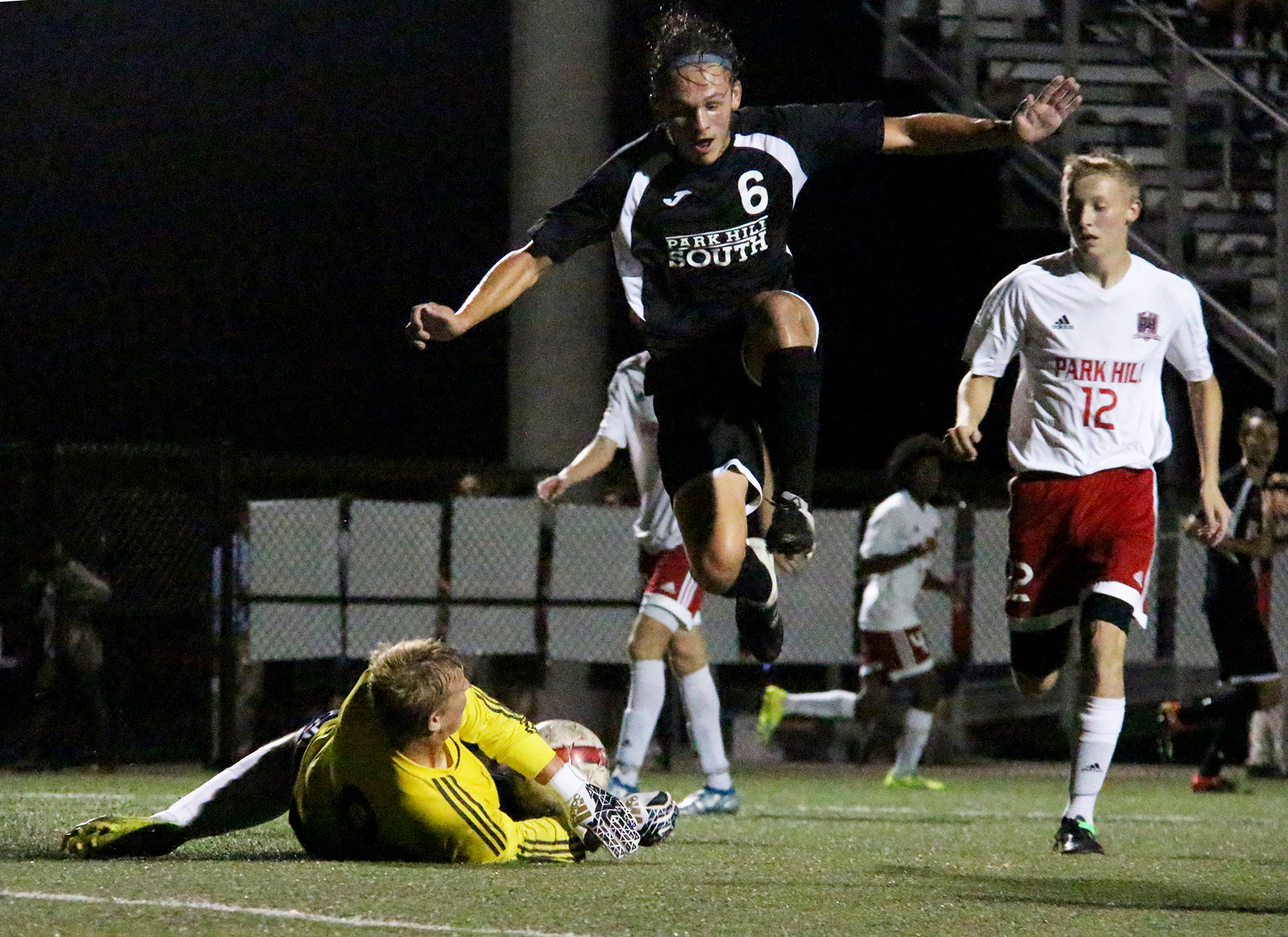 ROSS MARTIN/Citizen photos Park Hill goalkeeper Stefan Derra, left, slides in to stop Park Hill South’s Ryan DiBernardo (6) during a game Thursday, Sept. 8 at Park Hill District Stadium in Riverside, Mo. 