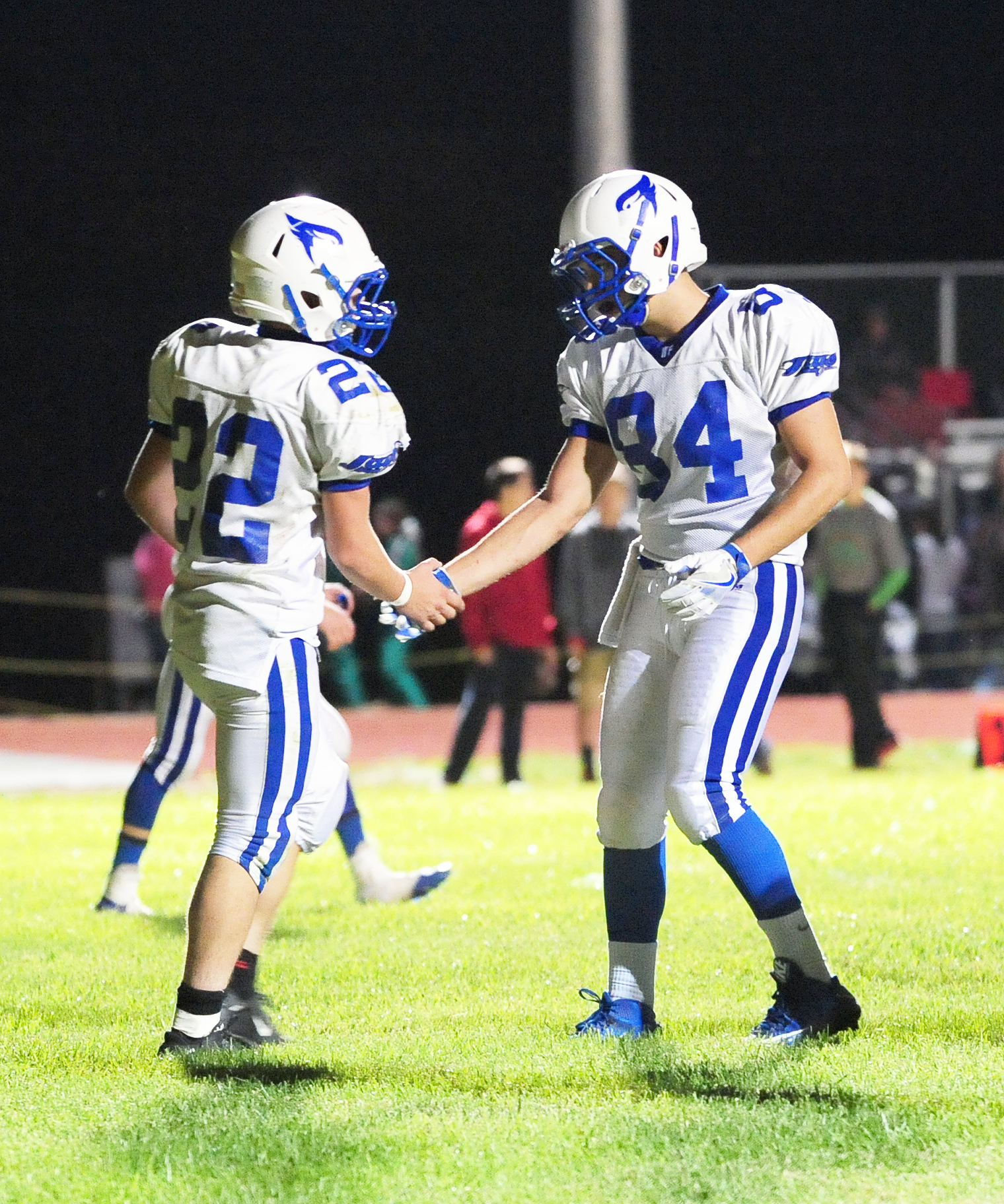 NICK INGRAM/Citizen photo West Platte running back Gavin Davis (22) shakes hands with teammate Alec Carson after a touchdown.