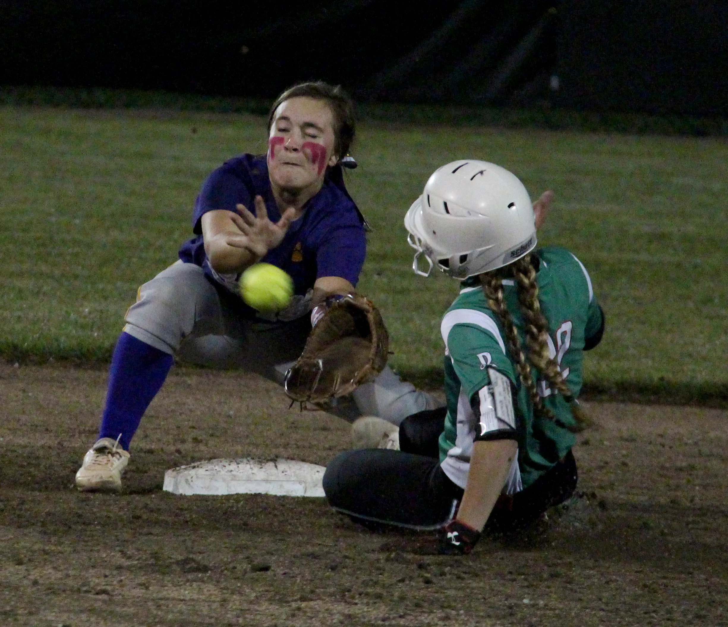 ROSS MARTIN/Citizen photo North Platte junior shortstop Alley Rickel, left, fields a throw from catcher Kyra Patch (not pictured) trying to catch Mid-Buchanan's Jill Rumpf stealing during a Class 2 District 14 first-round game Wednesday, Oct. 5 at Lathrop High School in Lathrop, Mo.