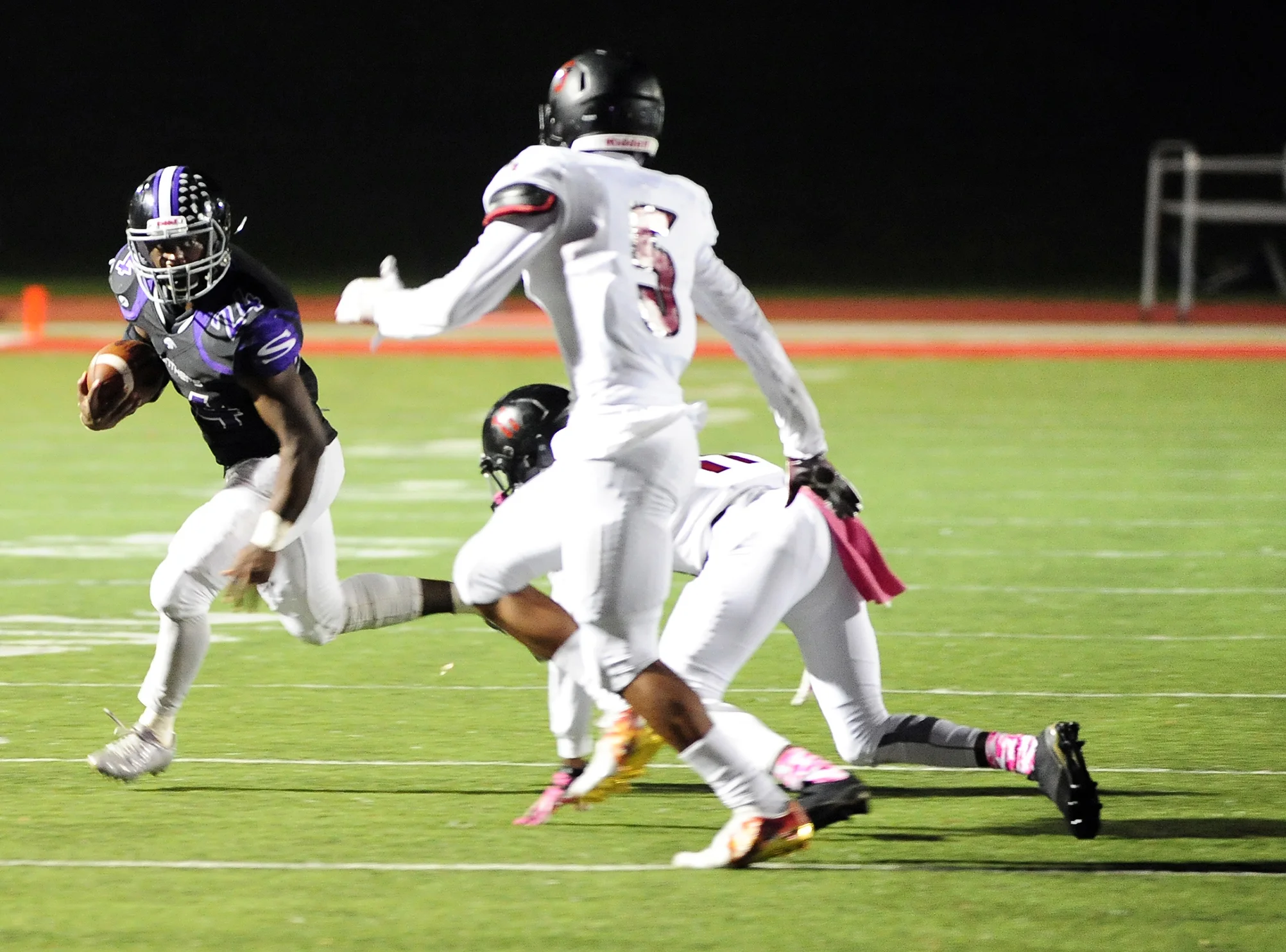 NICK INGRAM/Citizen photo Park Hill South senior running back Emanuel Butler, left, sizes up a pair of Lee’s Summit North defenders during a game Friday, Oct. 7 at Park Hill District Stadium in Kansas City, Mo. Park Hill South won 40-26.