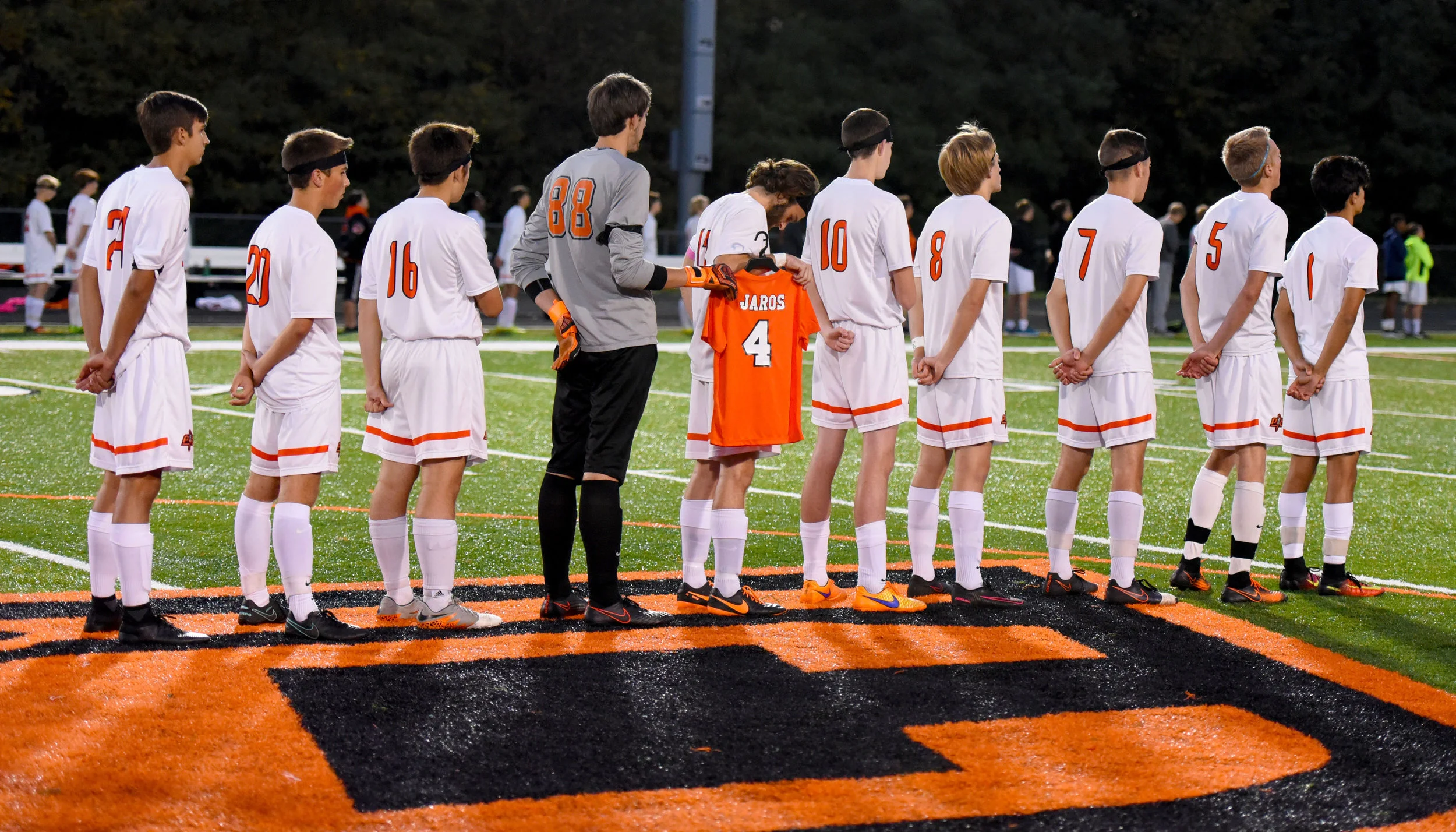 TODD NUGENT/Special to The Citizen Platte County's soccer team took the field with 10 men for the first four minutes of a match with Winnetonka on Thursday, Oct. 20 at Pirate Stadium. Prior to the game, the starters lined up for the national anthem with senior Zach Rolofson holding a special No. 4 jersey in memory of Landon Jaros, who died two days earlier due to complications with cancer. The 4-minute stretch at the start of the game were to honor the four years of Landon's life.