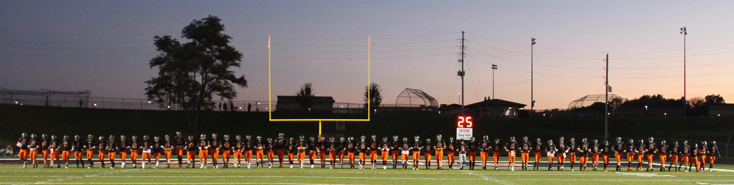 ROSS MARTIN/Citizen photo Platte County's football players took the field in a line with arms interlocked prior to the Class 4 District 8 opener with Winnetonka on Friday, Oct. 21 at Pirate Stadium.