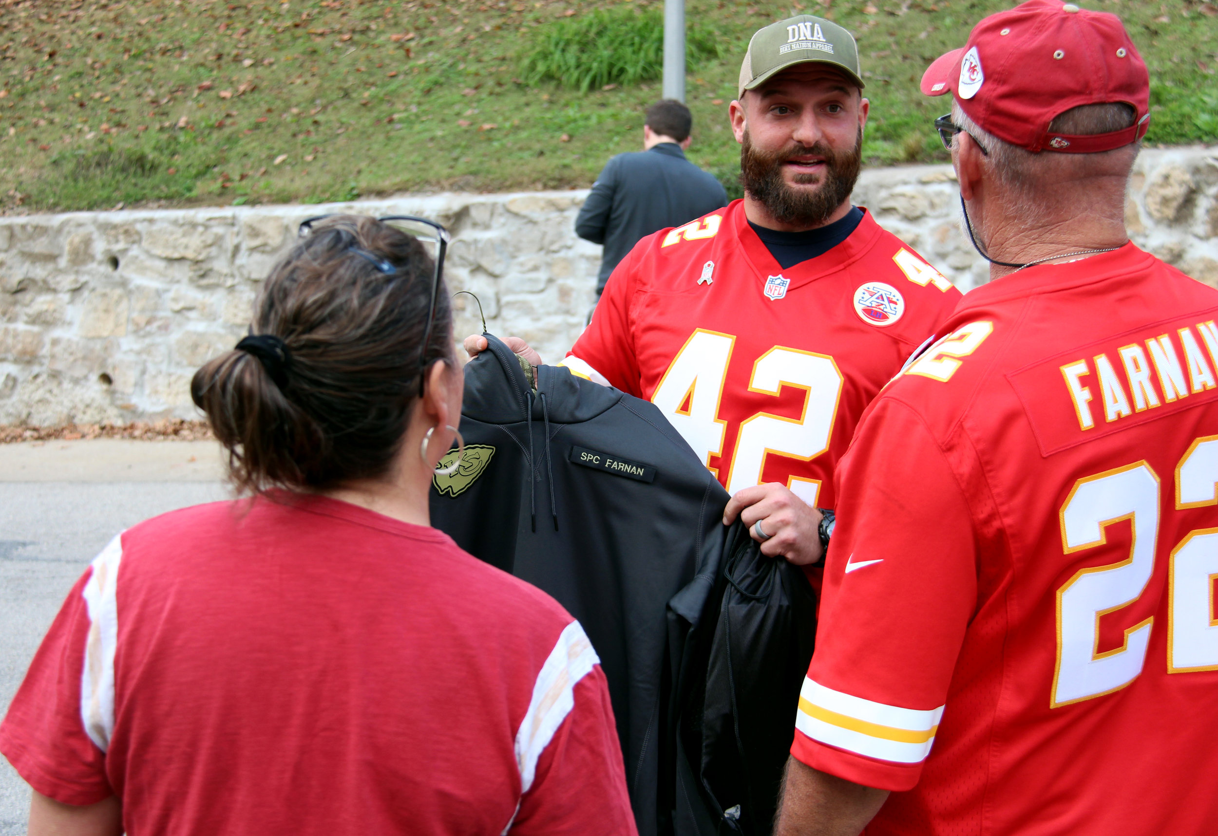 ROSS MARTIN/Citizen photo Kansas City Chiefs fullback Anthony Sherman presents Patrick and Deann Farnan with a custom hooded sweatshirt honoring their son Colby Farnan, killed at the age of 22 while serving the U.S. Army in Iraq. Sherman wore the shirt prior to the Chiefs' Sunday, Nov. 6 game against the Jacksonville Jaguars, and he made the presentation Monday, Nov. 7 at the Farnans' home in Weston, Mo.