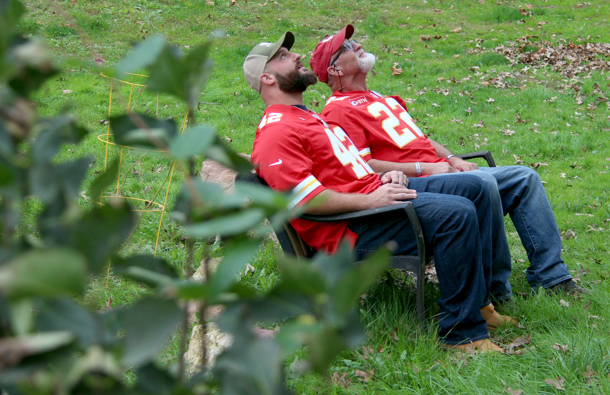 ROSS MARTIN/Citizen photo Kansas City Chiefs fullback Anthony Sherman, left, and Patrick Farnan look up at a tree planted in the backyard of the Farnans' home in Weston, Mo. Patrick Farnan told Sherman that he planted the tree 11 years ago after son Colby Farnan was killed while serving in the U.S. Army.