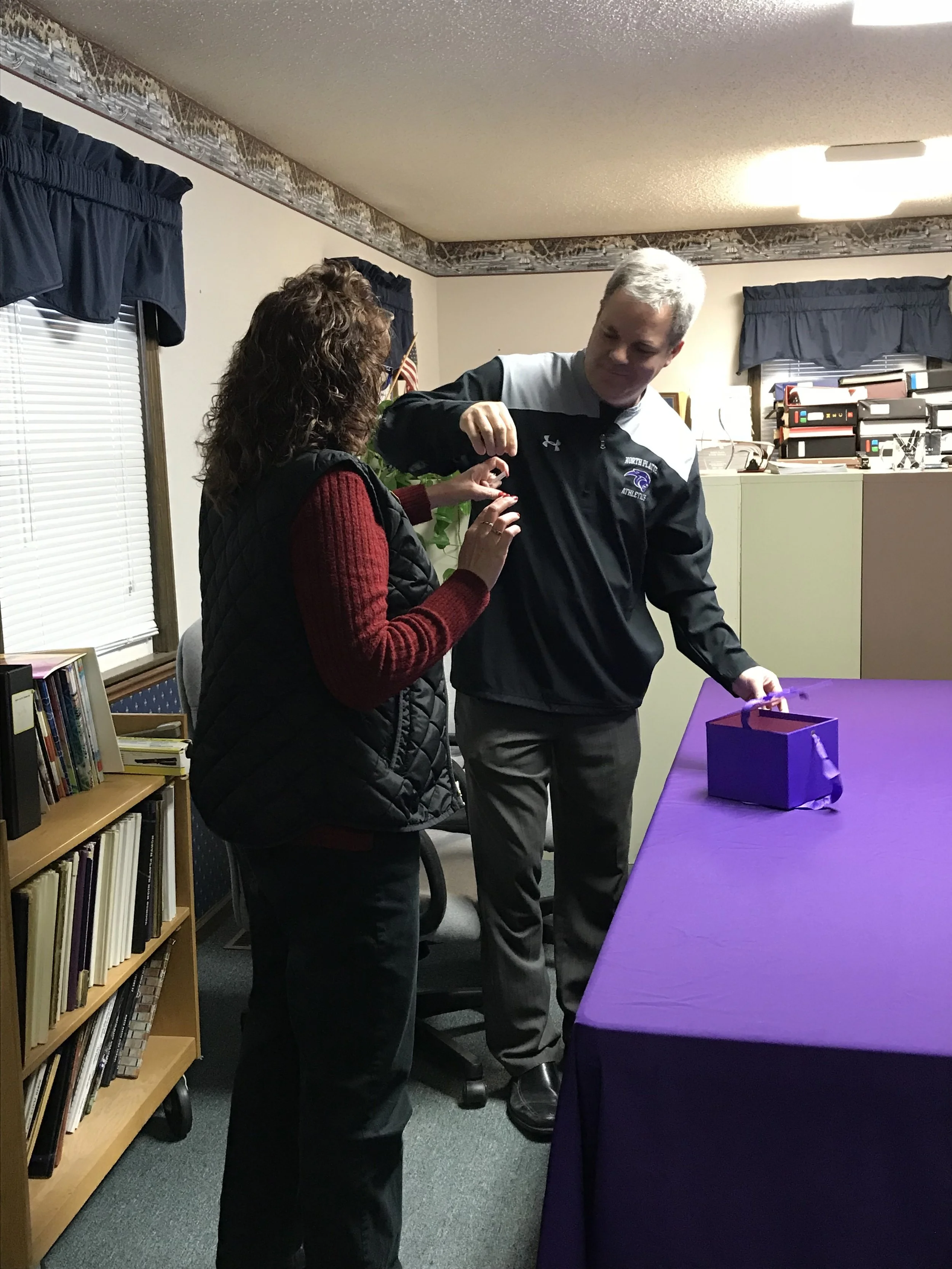 CODY THORN/Citizen photo North Platte superintendent Karl Matt, right, takes the name North Platte High School principal Michelle Johnson drew out of a purple box with the names of the candidates Karen Bartlett and Trace Stone in it to break the tie for a seat on the North Platte Board of Education. Bartlett became the winner of the drawing.