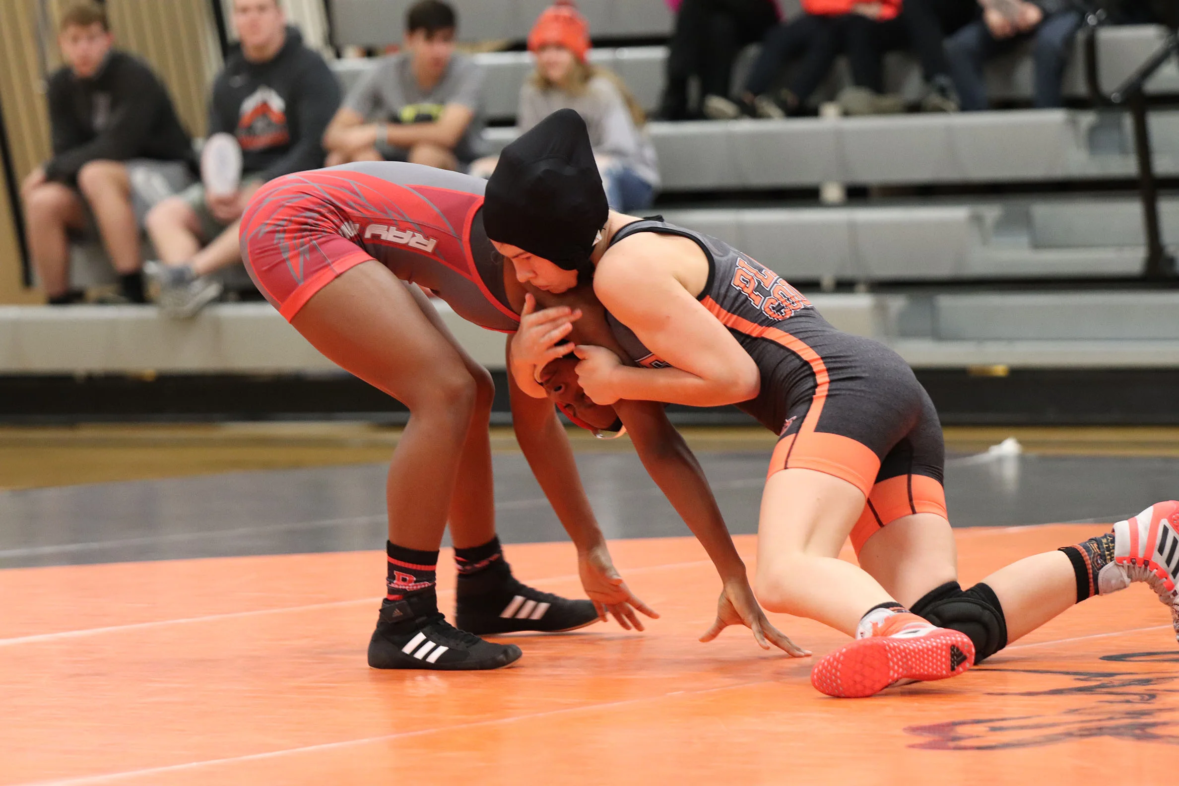 RILEY CRAWFORD/Special to the Citizen Platte County’s Avery Krahenbill, right, battles against Raytown South’s Makaryla Lottie during a match on Tuesday, Dec. 18 at Platte County High School. Krahenbill picked up an 8-3 decision to help the Pirates win 9-6.