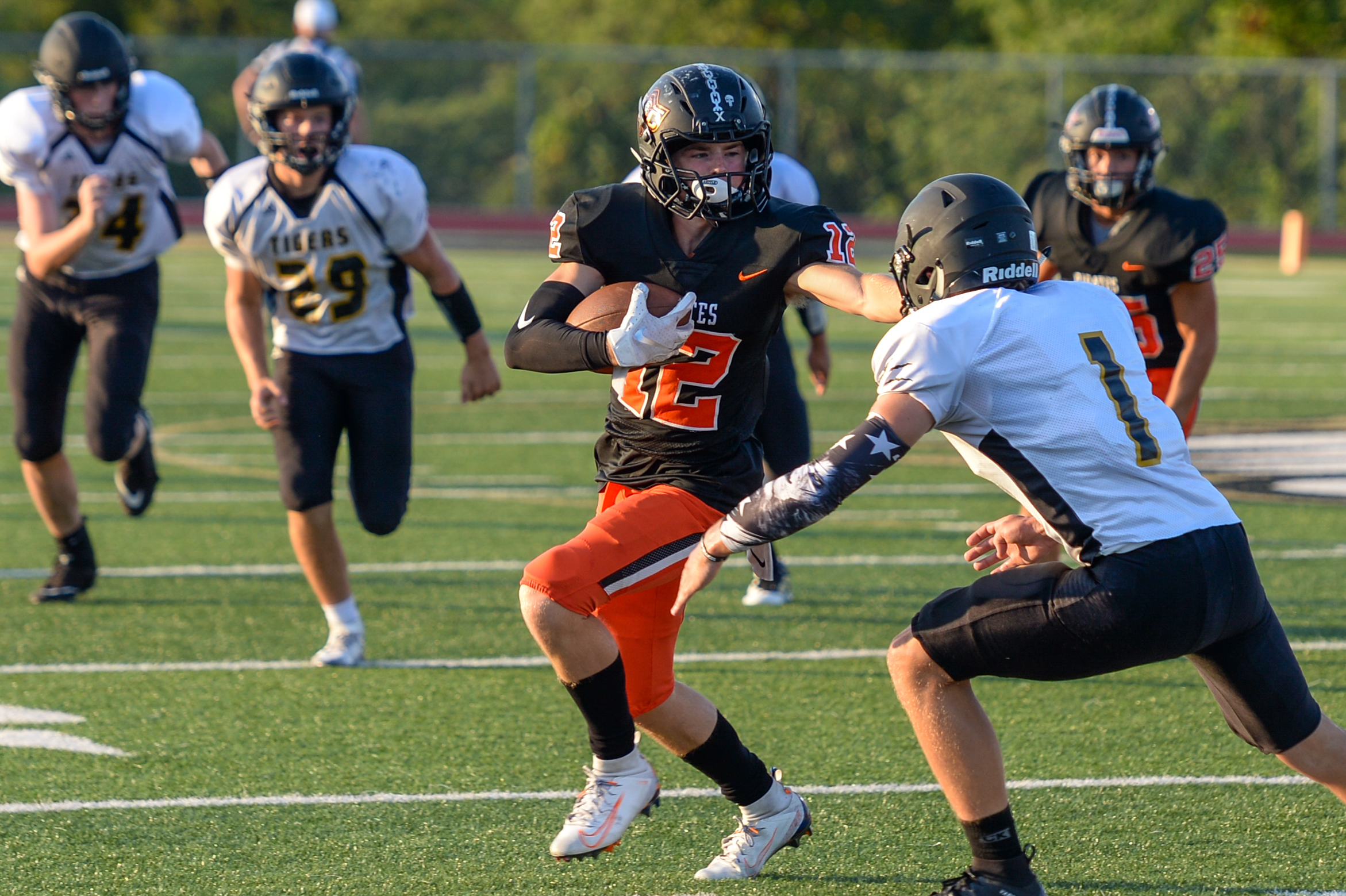 TODD NUGENT/Nugent Photography Platte County’s Cam Schieb stiff-arms an Excelsior Springs defender during a jamboree on Friday, Aug. 23 at Exclesior Springs High School.
