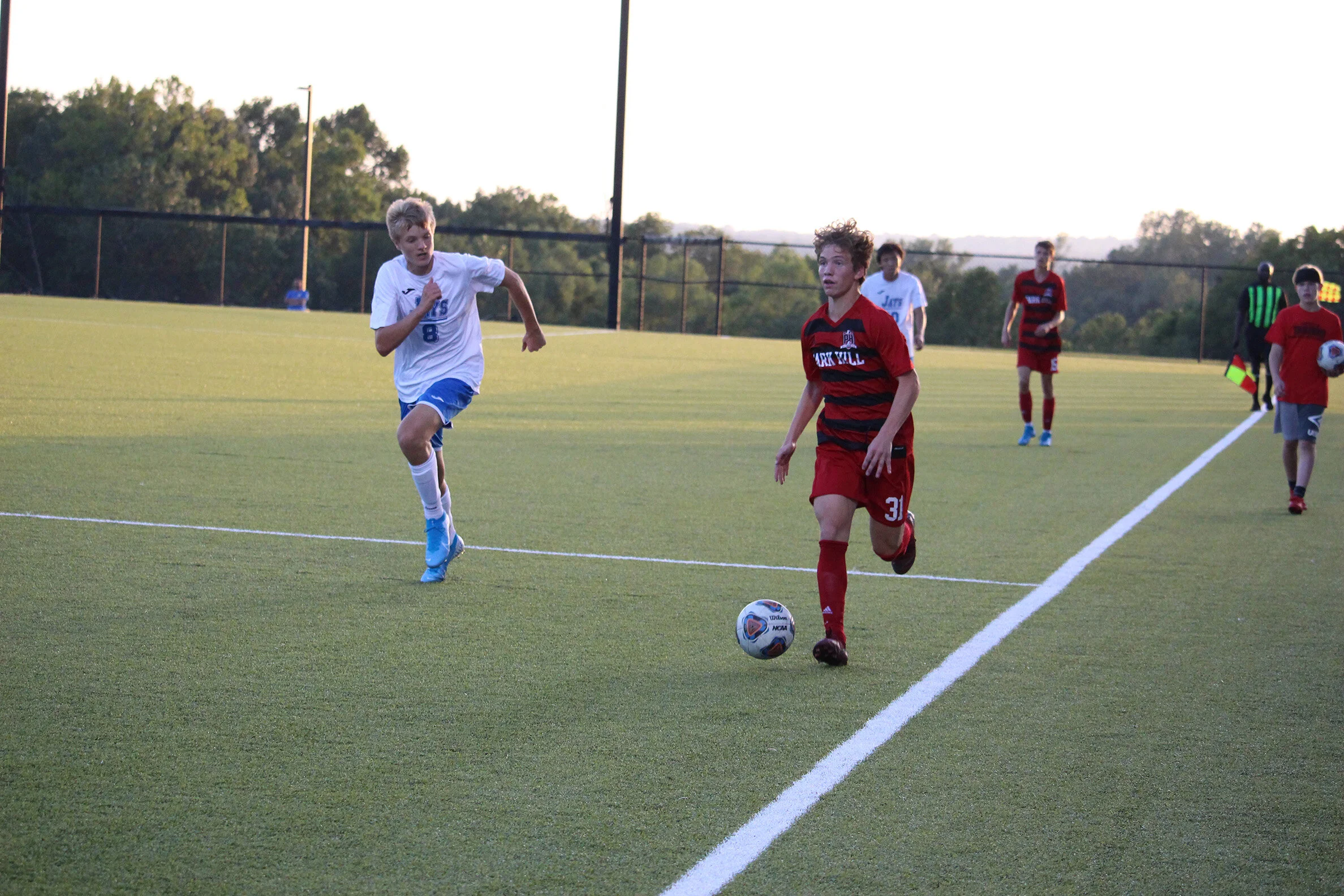 CODY THORN/Citizen photo Park Hill freshman James Betz dribbles the ball up the sidelines while being pressured by a Liberty player during a game on Thursday, Sept. 12 at the Park Hill District Soccer Complex in Riverside. Park Hill won the game 1-0.