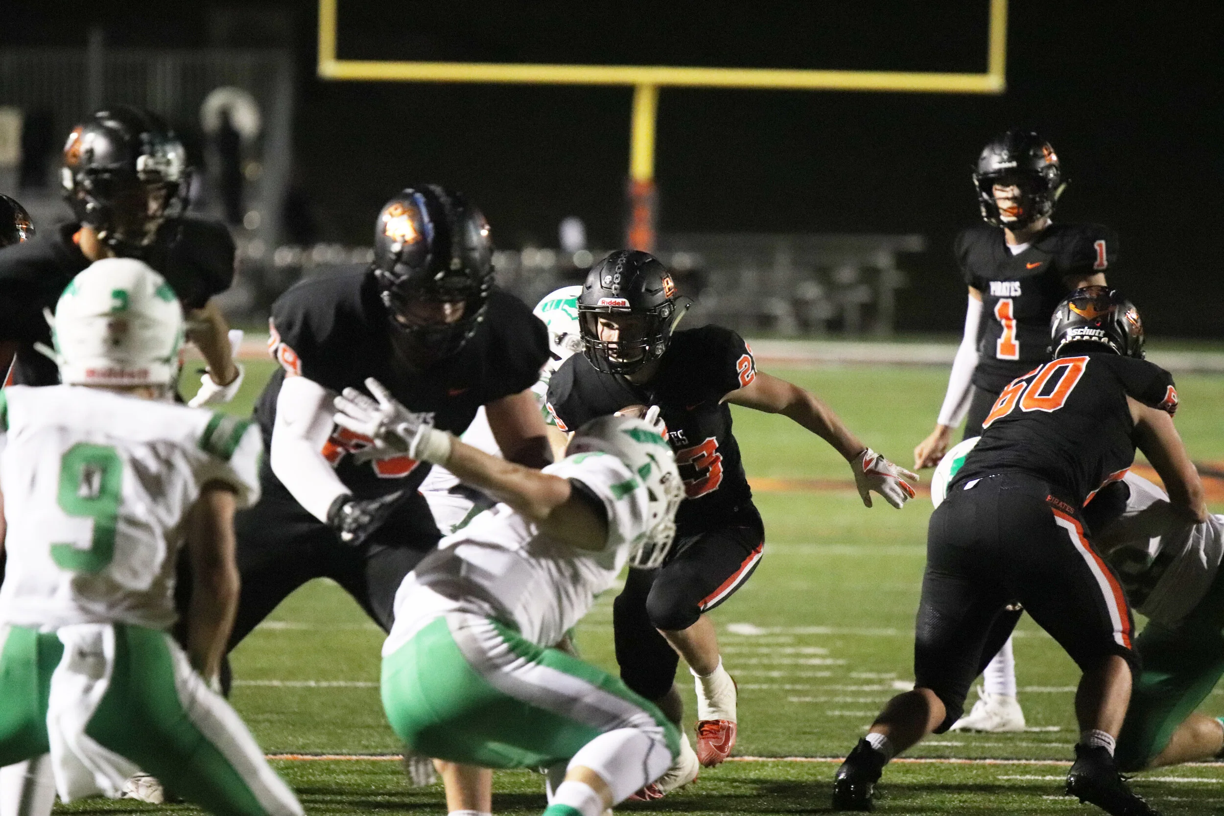 ROSS MARTIN/Special to the Citizen Platte County’s Cayden Davis, center, runs while getting an opening from offensive linemen Wyett Wallingford (79) and Luek Seigel (60) during a game against Smithville on Friday, Oct. 4 at Pirate Stadium. Platte County won 15-0.