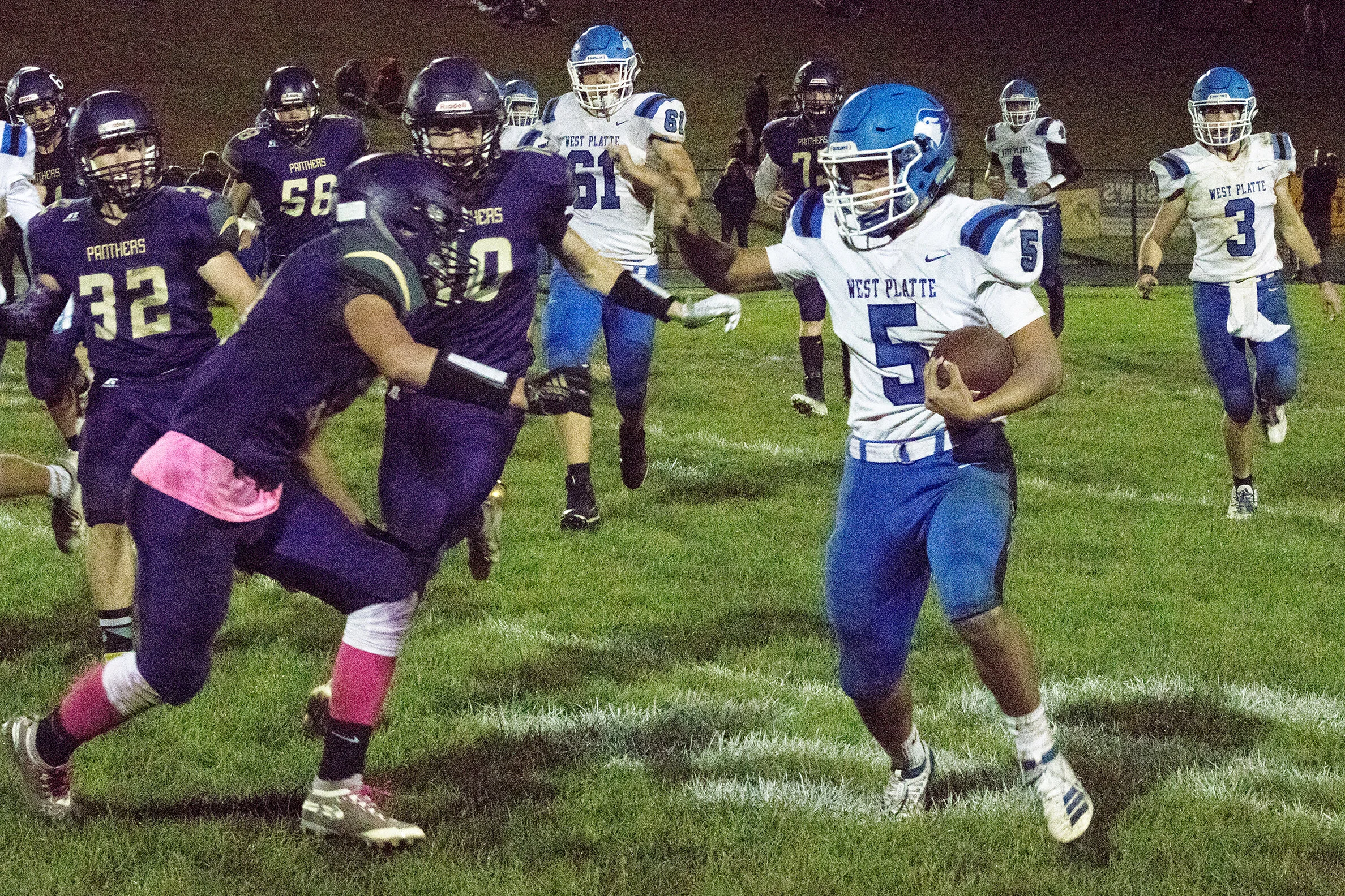DREW AGGUS/Special to the Citizen West Platte running back Brandon James, right, drives to find off a trio of would-be tacklers from North Platte during the annual Tobacco Stick rivalry game, held on Friday, Oct. 4 in Dearborn. The Panthers won the game 44-26 to retain possession of the stick.