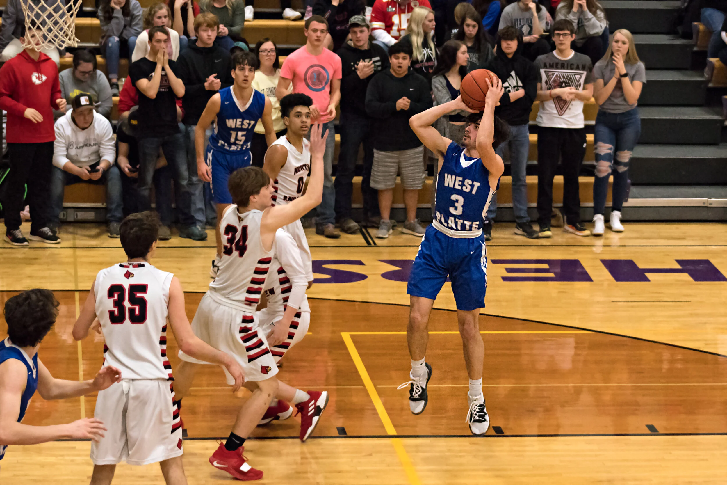 Brayden Cogan (3) pulls up for the shot with Clayton Linville (34) defending.jpg
