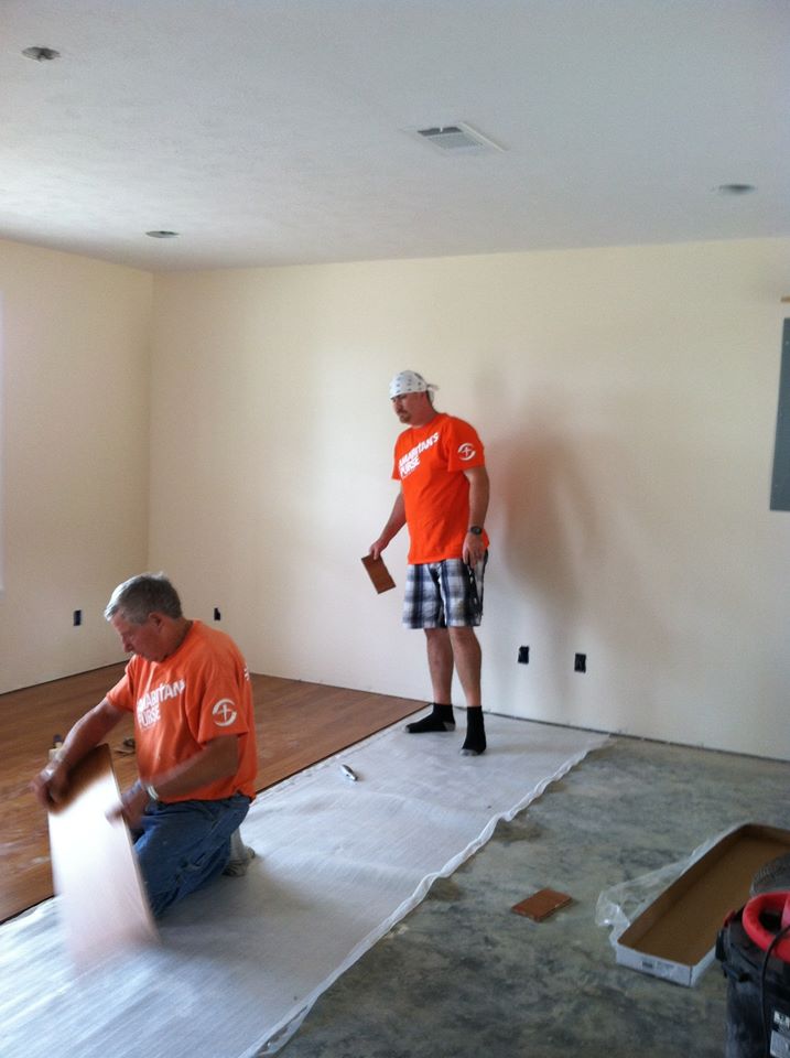 Laminate flooring being installed by Aaron, Ron and Barb