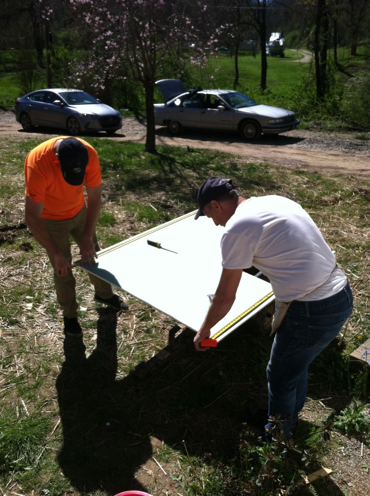 Terry and Aaron cut green board for the bathroom. 
