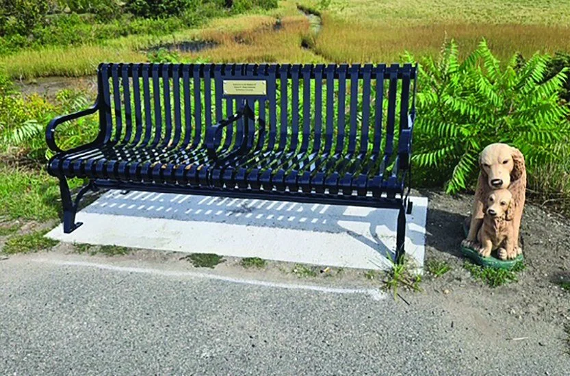 Who took Midas? My name is Barbara Corcoran; this picture was taken last Saturday. It is a memorial bench on the dike along Newport Road. My husband, Bob Corcoran, passed away last year, and I purchased the bench in his memory. Bob&rsquo;s best frien