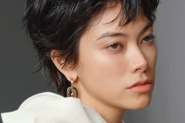 Close-up of a young woman looking to the side with a neutral expression.