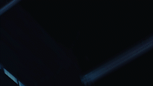 Dark background with a blue laser or light beam cutting through it.