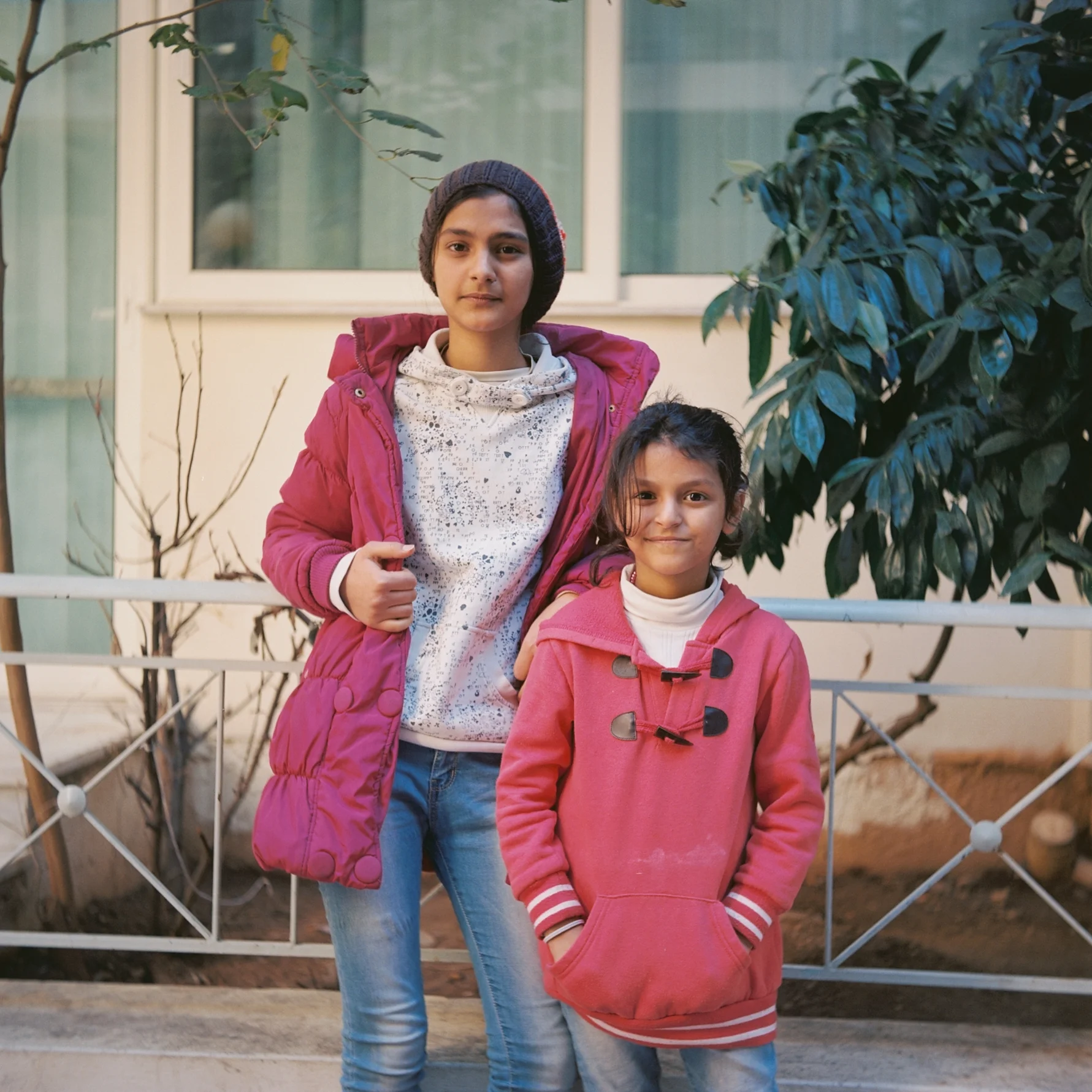 Alaa* (13) and Noura* (7) attend school and practice their Greek with the help of their friends. Photo: Talitha Brauer.
