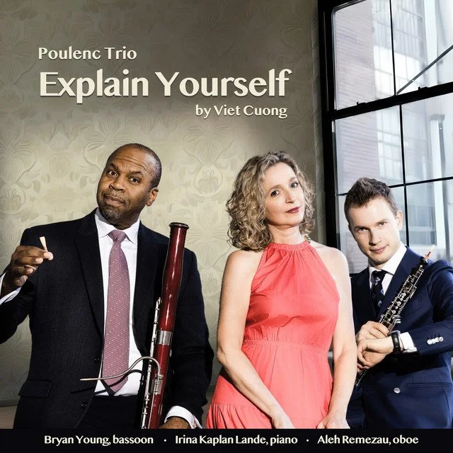 A promotional poster featuring three musicians with their instruments, for the Poulenic Trio's performance of 'Explain Yourself' by Viet Cuong. The trio includes Bryan Young, a bassoonist; Irina Kaplan Lande, a pianist; and Aleh Remezau, an oboist, s