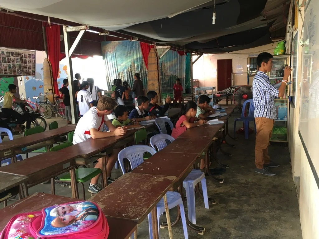 Andrew helping teach English to the local children.