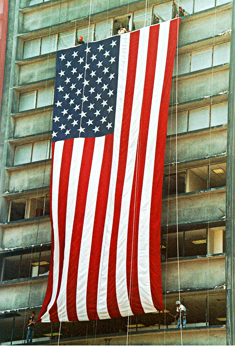 The Ground Zero Flag displayed on 1 Liberty in September 2001. Photograph by: Denise Lutrey Casalinuovo.