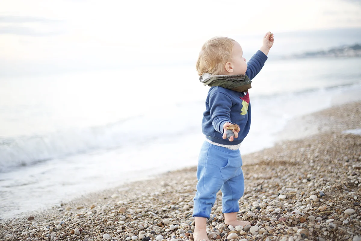 rowan daddy mamma picking stones beach.jpg