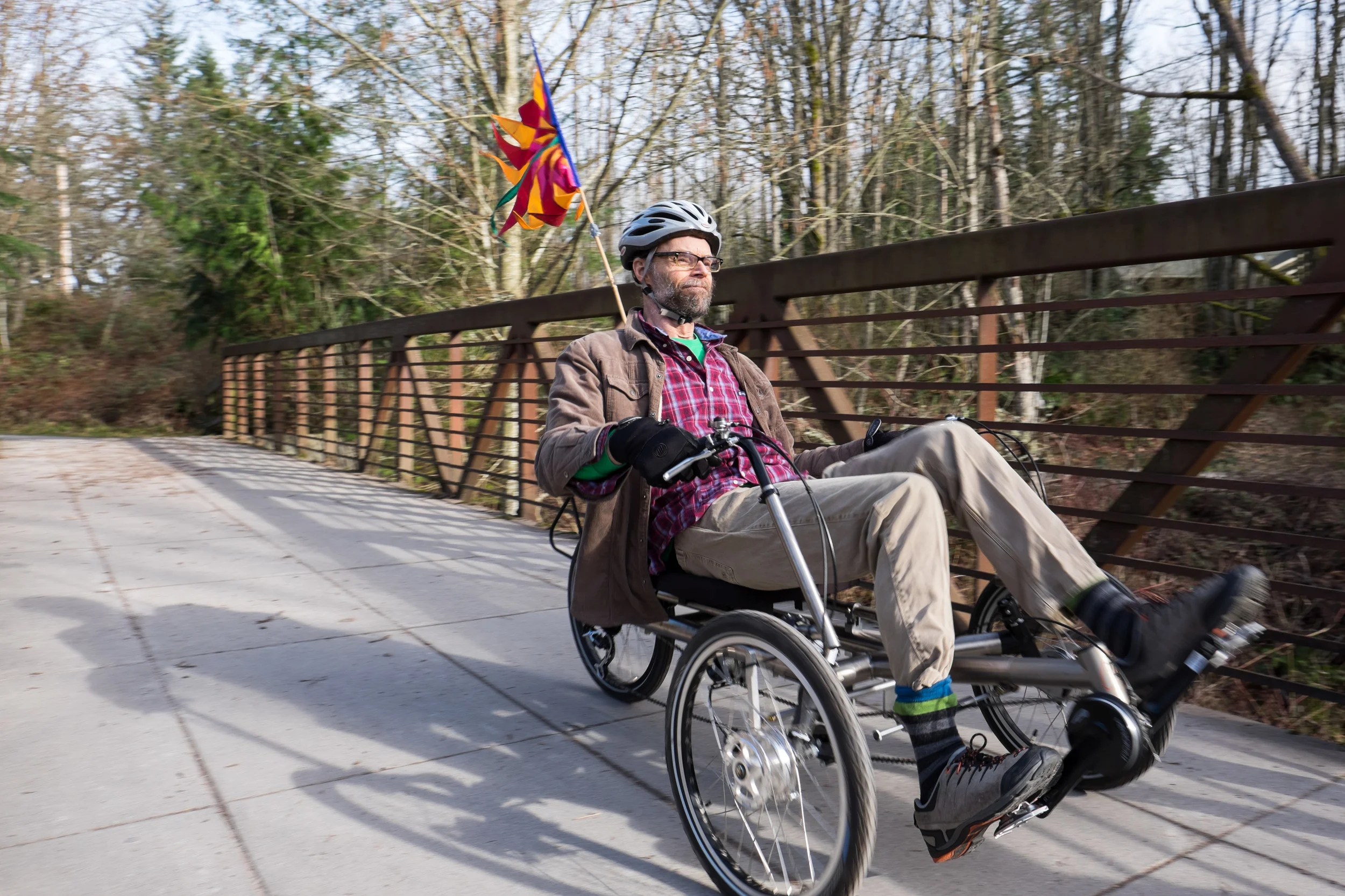 HERMANN ON HIS RECUMBENT BIKE ON BELLINGHAM’S RAILROAD TRAIL NEAR WHATCOM FALLS PARK. A RECUMBENT BIKE HAS HELPED HERMANN GET OUTSIDE TO STAY ACTIVE AND HAS ALSO SERVED AS AN ALTERNATE MODE OF TRANSPORTATION. For Klipsun Magazine