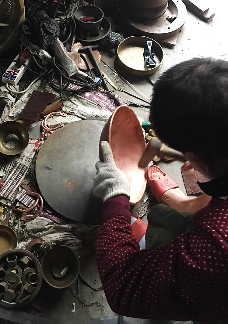 Hand forging of copper wok.png